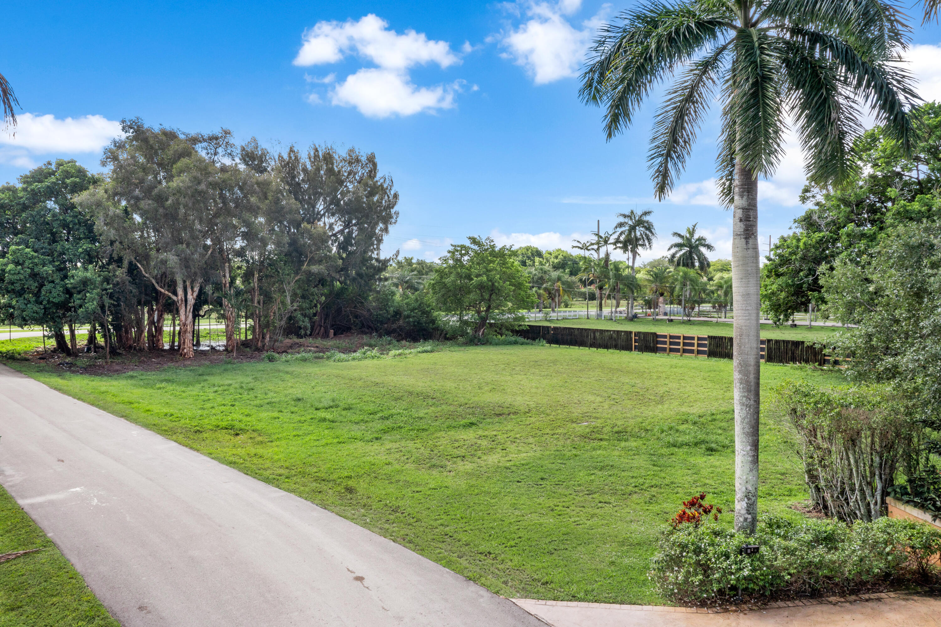 PRICE REDUCED BY $55,000! Rare opportunity to build your custom dream home on one of the last remaining ready-to-build estate lots in prestigious Plantation Acres. Situated on a private cul-de-sac, this exceptional homesite offers the perfect combination of privacy, luxury, and location in one of South Florida's most sought-after equestrian communities. Elevated buildable house pad already in place with power, water, and transformer on site, saving future owners significant time and development costs. Cleared and ready to build with mature trees remaining for added privacy, this property provides endless possibilities to create a luxury estate featuring a resort-style pool, guest house, sports court, detached garage, and expansive outdoor living areas. Ideally located in the heart of Plant