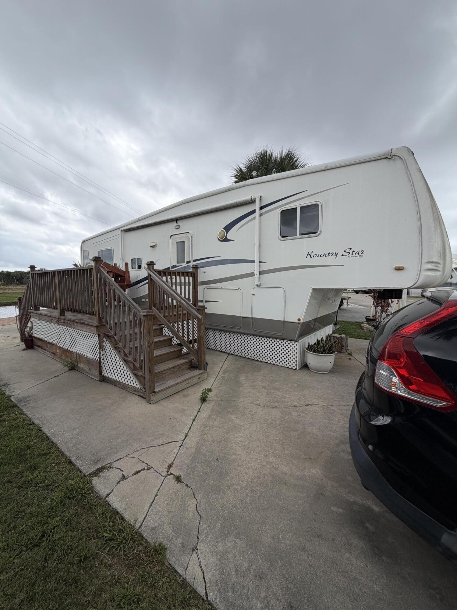 Welcome to Ancient Oaks,, a desirable 55+ community near world-famous Lake Okeechobee, known for some of the best fishing around! 1 Bed 1 Bath fifth wheel RV is located on a canal (no direct lake access). Ideal for seasonal living, this cozy retreat is ready for you to enjoy sunny Florida. The community offers a wide range of amenities, a heated pool, pickleball courts, shuffleboard, billiards room and a Marina with boat ramp and fish cleaning station. Pet friendly and full of activities, Ancient Oaks is perfect for those seeking an active yet laid-back lifestyle. Furnished w/golf cart and shed with washer & dryer. Pavers for back patio water view.