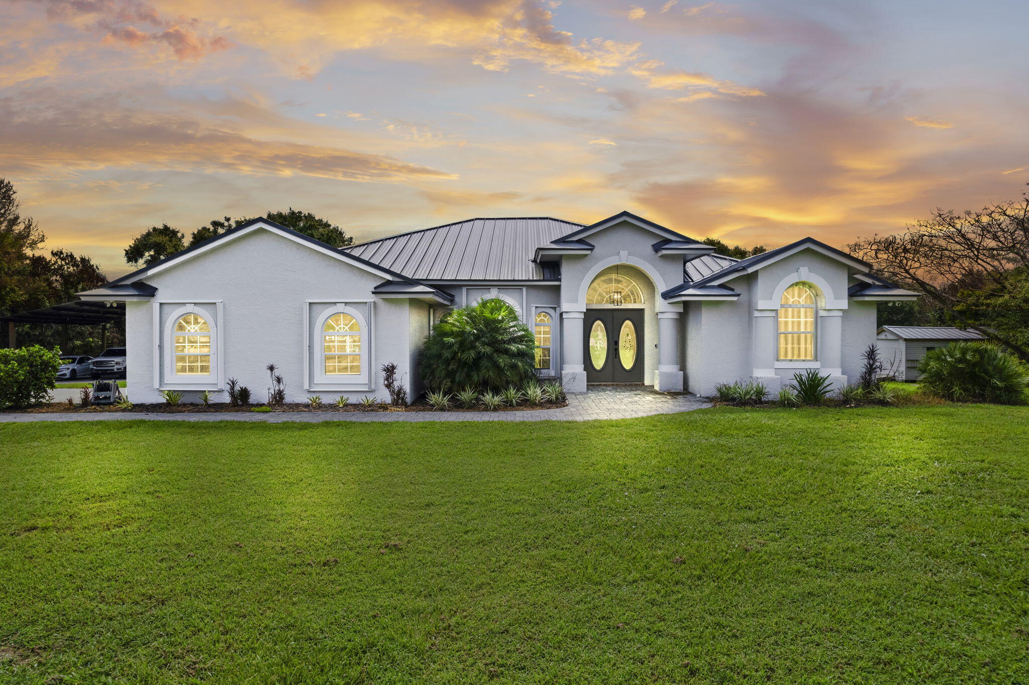 Don't miss the rare opportunity to own a stunning 4.42 - acre estate! This charming home features 3 spacious bedrooms, 2 full bathrooms, and an inviting open concept layout filled with natural light. This property boasts a sparkling pool and outdoor kitchen with a grill, making it ideal for entertaining. With ample space for cars, RV;s trailers, boats and all your favorite toys. With new metal roof and accordion shutters on all windows, this home combines style, and durability. Two sheds for extra storage. This Gem won't last