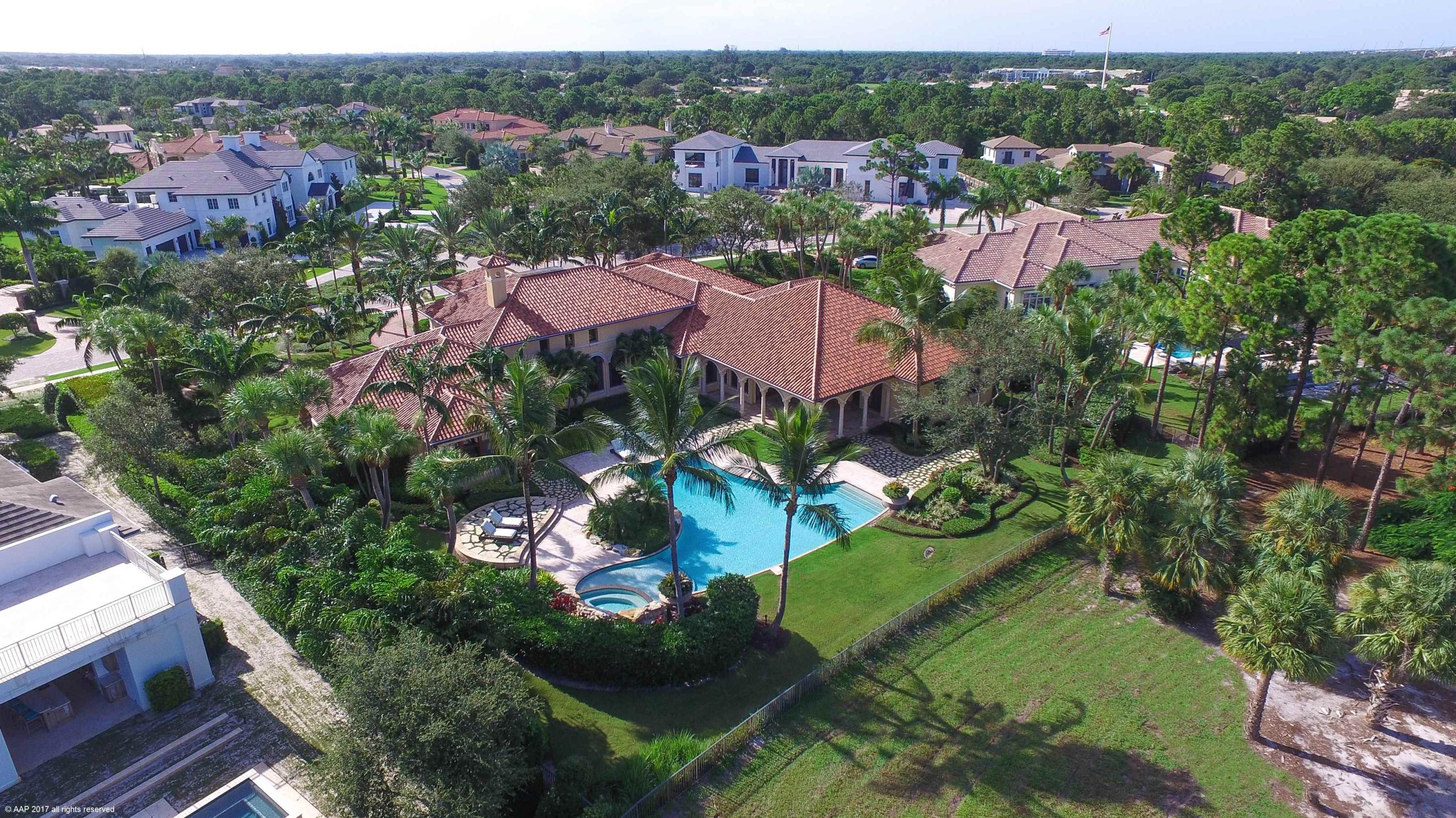 Beautifully appointed former builder model with stunning golf course view.  This home boasts volume ceilings, crown molding throughout, marble floors, his and her master baths, handsome library, theater room and club room, this home has it all!  The expansive lanai and custom heated pool and spa are perfect for entertaining, complete with built in summer kitchen and bbq.
