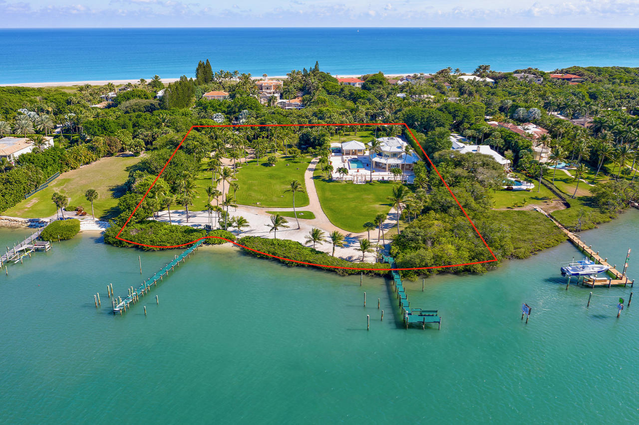 Exclusively available for the first time, this magnificent Jupiter Island double-lot spans 324 feet along the blue waters of the Intracoastal and stretches out over 3.2 acres. This is the largest Intracoastal lot available on prestigious Jupiter Island, making this truly a rare find. Currently deeded as two separate lots with two boat docks, and anchored by a four-bedroom guest house, this unique property affords intriguing opportunities. Occupy the immaculate guest house, while realizing the property's full potential. This is the last opportunity to design a truly grand private family enclave on the turquoise Intracoastal with a total allowable floor area of over 14,000 sf including two accessory buildings. Or develop two private residences, each with a total allowable floor area of over 9,000 sf including their own two accessory buildings, afforded by the separately deeded lots. See renderings for one home on one of the two lots. Lush landscaping and mature perimeter planting already exists providing seclusion and privacy. The sought-after location on the southern end of the Island allows for convenient access to restaurants, shops, airports and some of the area's finest golf courses. With the Jupiter Inlet in close proximity, with world class fishing only minutes away and the Bahamas only 55 miles off-shore, take advantage of the two deep water docks located within a desirable no-wake zone, providing ample room for yachts, sport fishing boats and other toys. Launch paddle boards and kayaks from your sandy shoreline. Peace and solitude exude from this exclusive private oasis, offering the most stunning Florida sunsets over the Intracoastal.