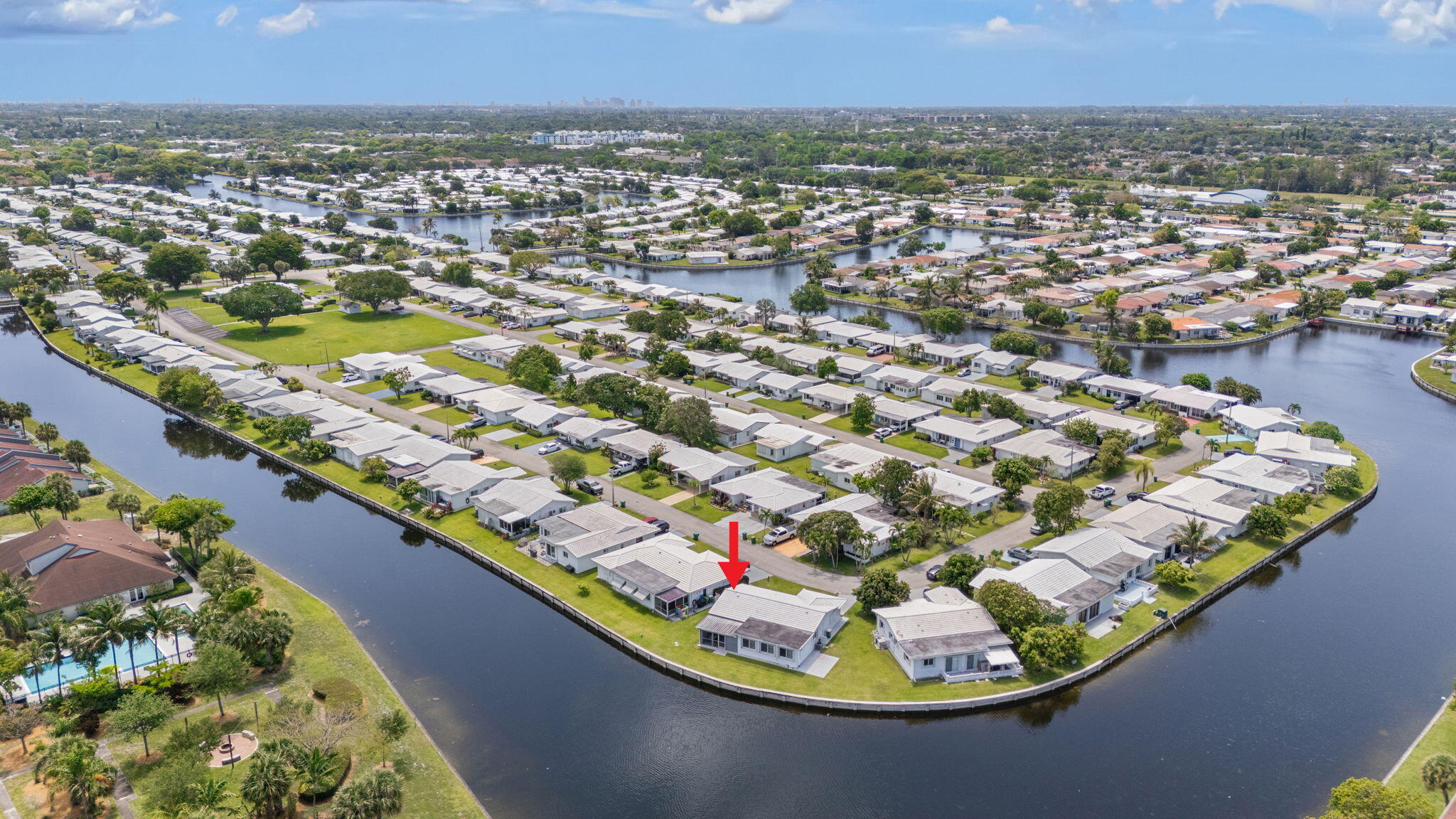 Rarely available oversized corner lot with stunning wide water views on two sides, offering exceptional privacy in the Mainlands of Tamarac Lakes 55+ community. This beautifully updated home features plantation shutters throughout and neutral large-format tile flooring for a clean, modern feel. The newer white kitchen is equipped with stainless steel appliances and ample cabinetry, perfect for everyday living and entertaining. Impact windows provide added protection and energy efficiency, while the tile roof (2017) offers long-term peace of mind. Bright living spaces are filled with natural light and showcase tranquil water views. Low-maintenance living with the HOA covering lawn care plus access to the clubhouse and pool. Conveniently located near shopping and dining.
