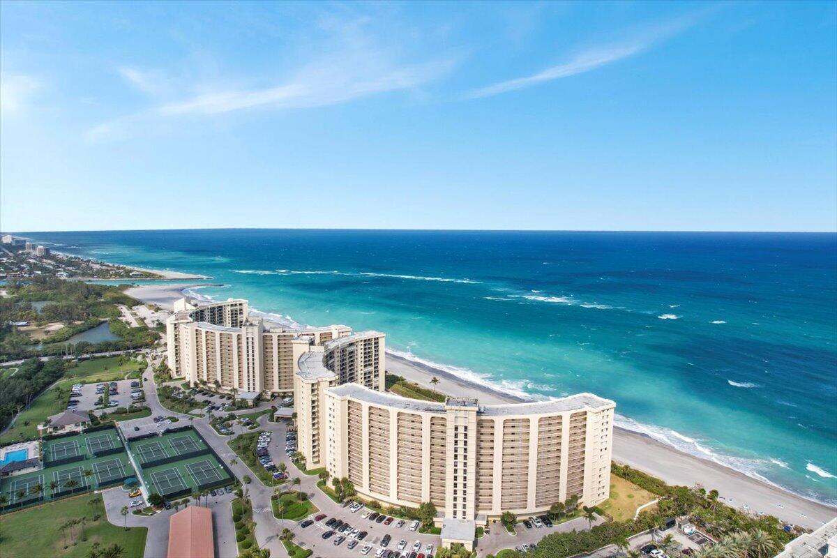 Seasonal Oceanfront Luxury at Jupiter Beach - Embrace the ultimate coastal lifestyle in this beautifully appointed 2-bedroom, 2-bath beachfront condo, perfectly situated in the highly sought-after Ocean Trail community in Jupiter, Florida. This terrace-level retreat offers the rare combination of direct beach and pool access with all the conveniences of resort-style living. Step outside to your expansive private patio with seamless access to the pool and the soft sands of Jupiter Beach - no elevator needed. Inside, you'll find a light-filled, thoughtfully designed interior, featuring two spacious bedrooms with King-size beds, a fully equipped kitchen, in-unit laundry, and ample storage for extended stays. Ocean Trail offers guard-gated security and top-tier amenities including an  oceanside pool & jetted spa, tennis courts, a fitness center, scenic walking trails, and inviting BBQ areas making every day feel like a vacation. Located just steps from the beach and across from Jupiter Dunes Golf Course, this condo places you minutes from Jupiter Inlet, award-winning waterfront dining, boutique shopping, fishing charters, and the upscale Jupiter Beach Resort & Spa. Whether you're lounging on the terrace, strolling the shoreline, or entertaining guests, this home offers the comfort of a beach house with the perks of a luxury getaway. Don't miss this opportunity to spend the season in one of Jupiter's premier beachfront residences. Call today to schedule your private tour and secure your slice of paradise.