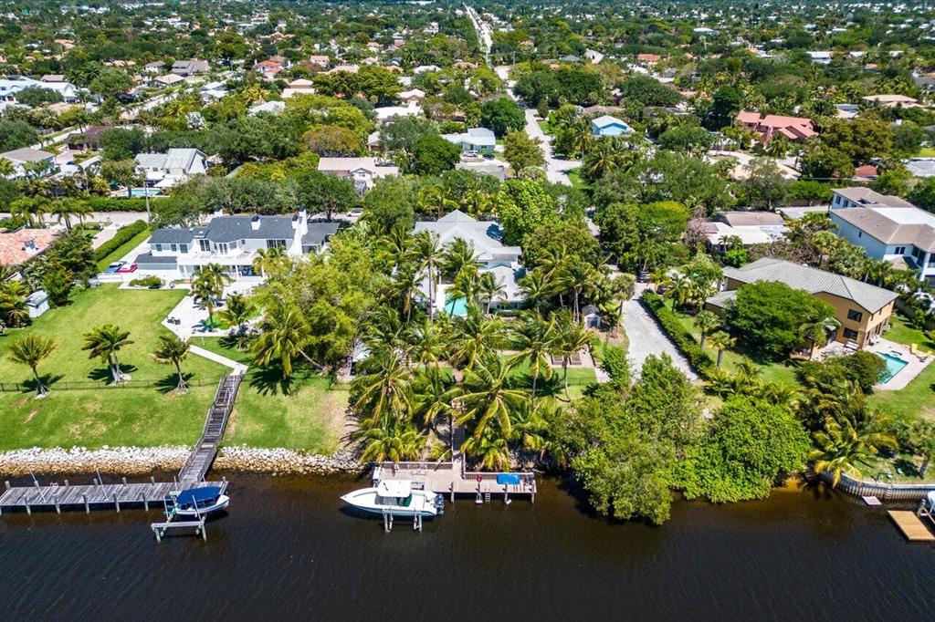 Remastered West Indies/Farmhouse-inspired Waterfront estate sited on aprox 3/4 ac with 100' of waterfront. Mansion-estate with reimagined interior which include chiseled edge castle rock marble on ground level and hardwood floors on the upper level, functional island gourmet kitchen with top-tier appliance package, and luxe primary suite boasting private balcony. Resort-style private pool entertainment loggia with summer kitchen and cabana. Hone your pizza making skills as you proceeded to the wood-burning entertainment gazebo. Other amenities include club room, formal Dining,Piano and living room accompanied with waterfront office with lounge, and theater/media/Gym with sauna. Boaters showcase room for charting trips. If you want a luxurious but casual coastal home, act now!