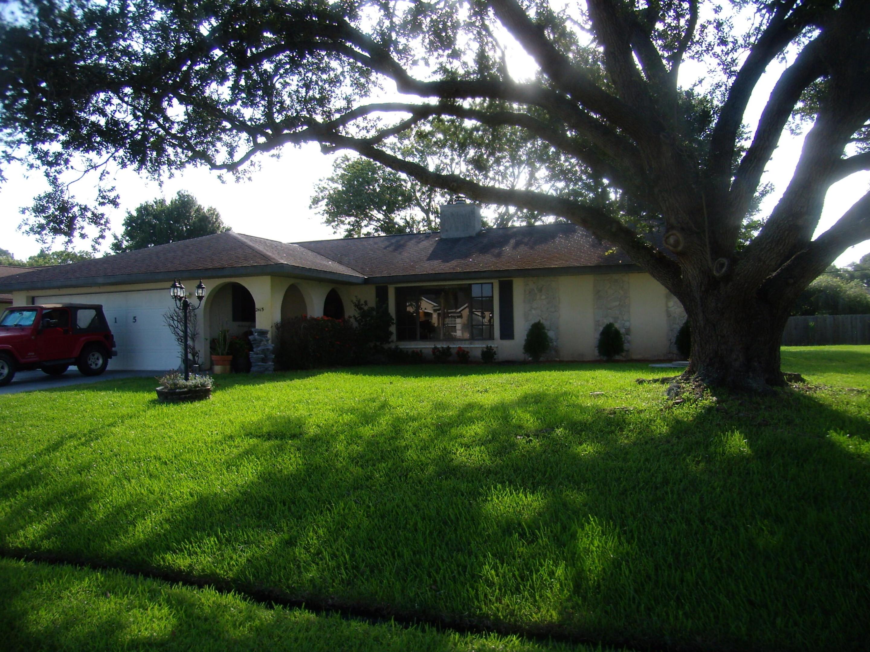 FIXER UPPER HOME, being sold AS IS with right to inspect. Large open floor plan with 2 bedrooms and 2 full baths. Formal dining and living rooms with fireplace. A family room that is off the kitchen and the screened lanai. 2 car garage and large level back yard. NO HOA. Work on master shower and floor started. Roof is original but have a bid for a new roof. This home is ready to be molded into your dream home. Call today to view.