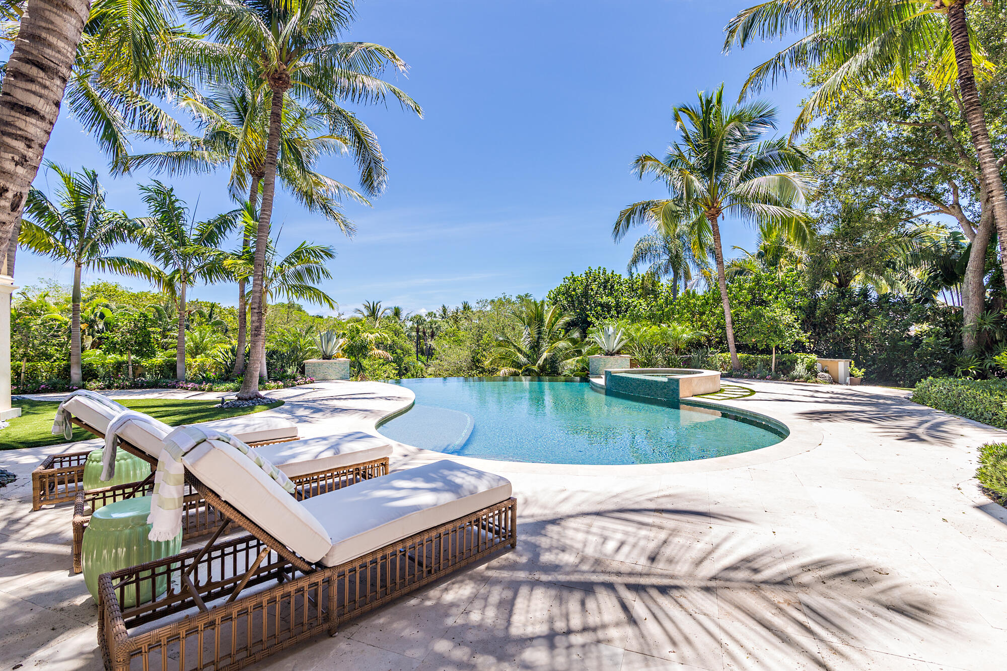 This elegant Mediterranean estate, situated on a high elevation, offers unparalleled views of the expansive tropical canopy of trees and the water below.   The residence has 12,474+/- total square feet, with 6 bedrooms, 7 bathrooms, and 1 half bath.  The home offers an array of entertainment with a billiards room and bar, a movie theatre, a wine room, spacious eat-in kitchen with family room, a screened in patio with built-in grill and full bath,  a pool and spa, dock with lift, 4-car garage, and much more.  Additional details include beautiful moldings and beams, high ceilings, exquisite cabinetry, high-end closets, large terraces, private balconies, and a full house generator.  Seminole Landing is a small gated community with full-time security, tennis courts, beach access, and close proximity to restaurants and shopping.