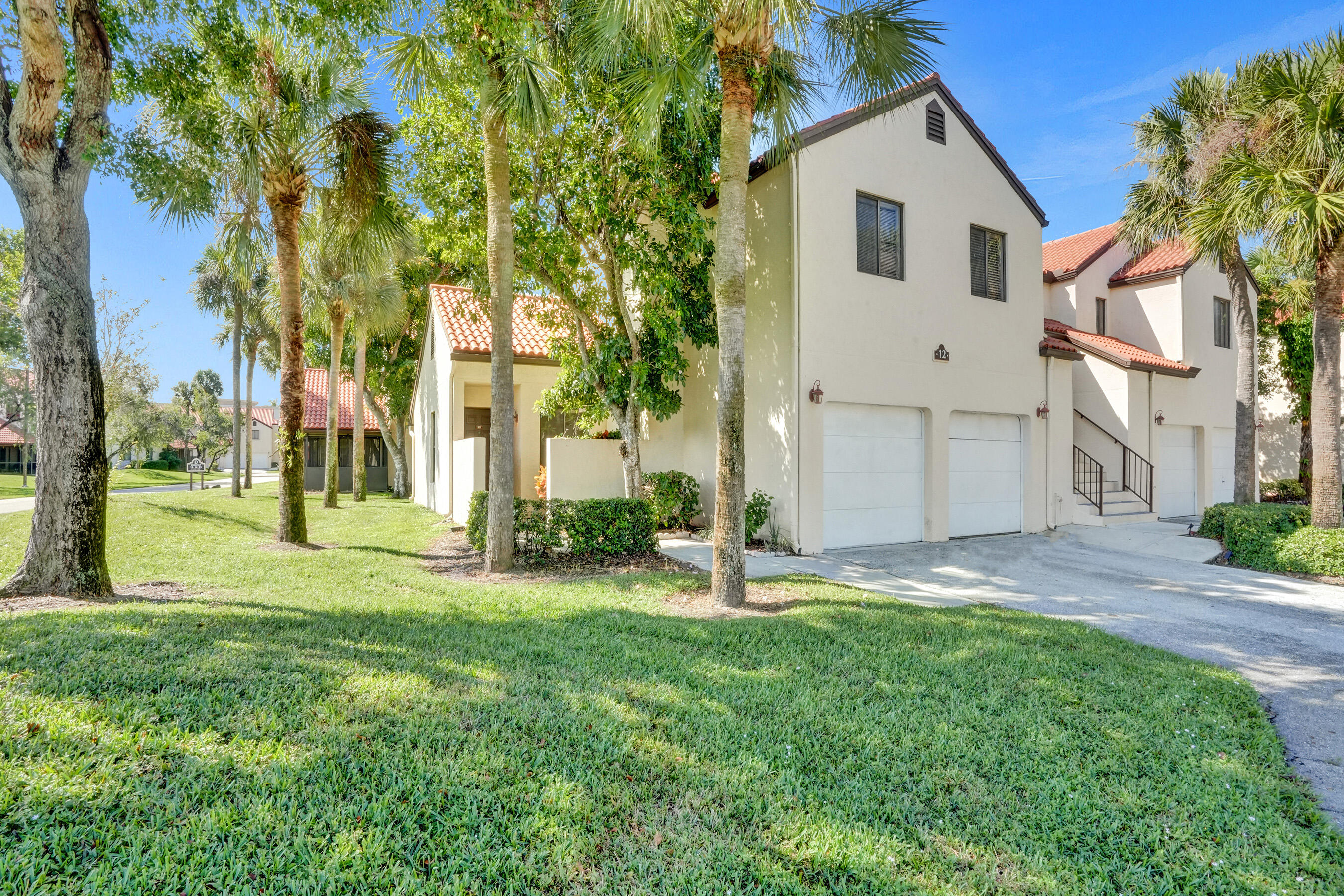 Corner Unit in gated complex. South Lake is a hidden gem in the heart of Boynton Beach. Kitchen has updated cabinets, SS appliances, undermount sink and Granite counters. Entire unit fully repainted, new wood style floors in both bedrooms, garage floor just repainted with flake finish. Walk in closets in both bedrooms, huge master bedroom, fully screened patio. 1 car garage with washer and dyer. 1 attached Garage parking space and 1 assigned driveway space in front of the garage. Additional parking in community lot. HOA pays Roof Repairs and replacement, insurance, cable, internet, management fees, common area maintenance. Community also offers tennis courts, pool, clubhouse, picnic area and a full gym. Schedule your showing today, priced to SELL!
