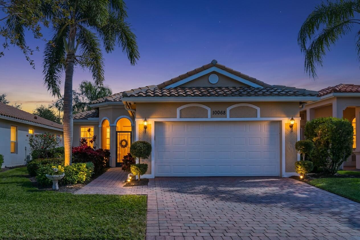 GAS COOKING • FULL IMPACT GLASS • RESORT AMENITIES • CABANA POOL PROXIMITY. Ideally positioned directly across from the neighborhood cabana pool, this home offers the luxury of a private-pool lifestyle without the maintenance costs or high insurance premiums. This exceptional 2-bedroom plus den, 2-bath former builder model Camellia lives LIKE YOU HAVE YOUR OWN FULL-SIZED OASIS just steps from your front door, perfect for a quiet morning swim or relaxing poolside without the daily upkeep. Located in the award-winning 55+ community of Vitalia at Tradition, this "Future-Proofed" retreat is designed for the savvy Florida buyer, featuring full impact glass windows, a whole-home water filtration system, a generator hookup, and a new water heater (2025). Inside, 12-foot vaulted ceilings and  custom crown molding create an airy, upscale atmosphere. The kitchen features sleek quartz countertops and gas cooking, while the great room flows effortlessly into an extended, screened, and pavered lanai, perfect for sunset cocktails and outdoor entertaining. The primary suite serves as a private sanctuary with dual walk-in closets, while the versatile den, complete with a charming window bench and shelving, is the ideal "Zoom Room" or hobby space. Life in Vitalia is a permanent vacation with access to the 24,000 sq. ft. Captiva Club, fitness center, pickleball, and a vibrant social calendar. Enjoy the Tradition Square's shopping,  dining and events. With maintenance-free living including lawn care, high-speed internet, and cable, this is turn-key luxury positioned exactly where you want to be.