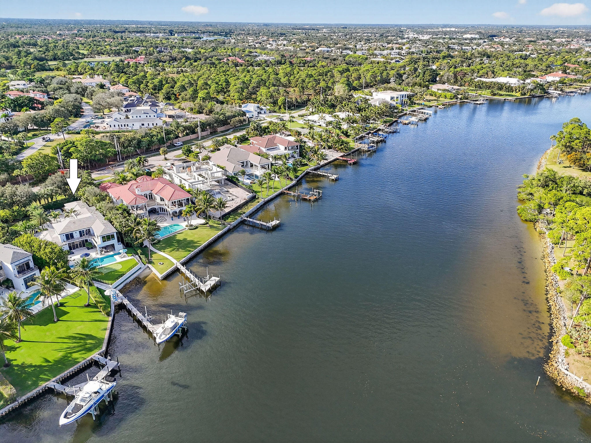 Set behind the gates of an intimate waterfront enclave, this beautifully renovated Intracoastal estate offers a rare blend of scale, privacy, and lifestyle. Positioned on an expansive three-quarter-acre lot with direct, east-facing water frontage, the home captures sweeping views of South Florida's most coveted waterway from multiple vantage points. Designed to feel both inviting and expansive, the residence features approximately 5,000 square feet of living space with six bedrooms, six baths, and two half baths, complemented by a three-car garage. Multiple living and entertaining areas allow for comfort and privacy, making the home equally suited for quiet evenings or hosting family and friends. Outdoor living is a true highlight, with amenities curated for both relaxation and recreation. Enjoy a heated pool and spa, a low-maintenance turf yard with a private putting green, and your own dock complete with a 40,000-pound boat lift and private beach area an exceptional setup for boating and waterfront enjoyment. Located in the heart of Palm Beach Gardens within the prestigious Palm Beaches, the property is just about a mile from the Atlantic Ocean's pristine beaches and offers effortless access to world-class dining, upscale shopping, vibrant nightlife, and major roadways including I-95. A rare opportunity to own a turnkey Intracoastal home in a premier gated community this is waterfront living at its most refined and rewarding. ** Some of the images have been virtually staged.