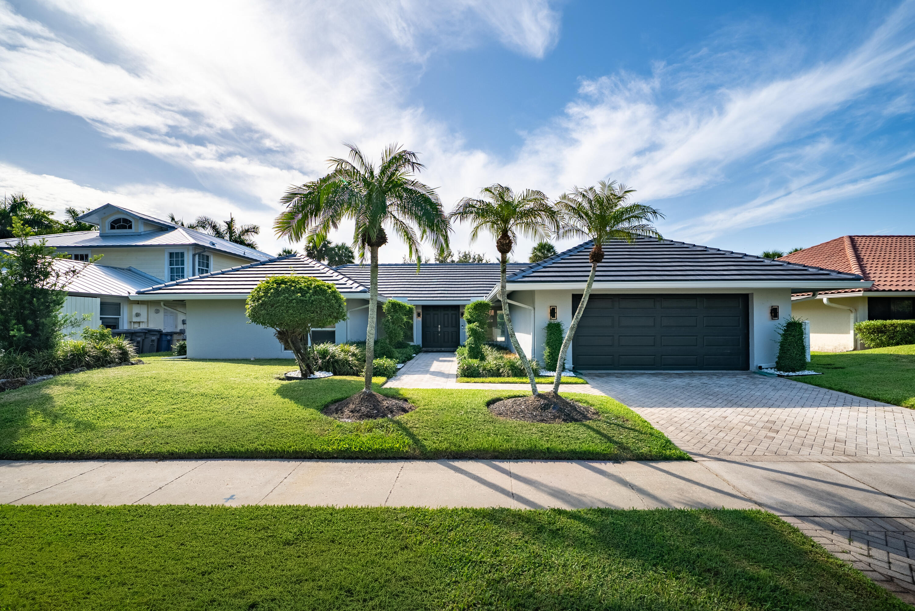 Fully renovated Brookfield home overlooking the Jack Nicklaus golf course, located in a beautifully maintained community with low HOA fees and lush, mature landscaping throughout. Ideally situated near Saint Andrew's School and Pine Crest School, you're just 5 minutes from Town Center at Boca Raton, about 12 minutes from Mizner Park, and have quick access to I-95.  This home features a brand-new 2025 roof, full impact windows and doors, and expansive wraparound sliding glass doors that create a seamless indoor-outdoor living experience. The private backyard is built for entertaining, with a heated pool and spa overlooking the golf course.  Inside, you'll find spacious bedrooms, a generous primary suite with a large walk-in closet, dual-zone air conditioning, and the added peace of mind of