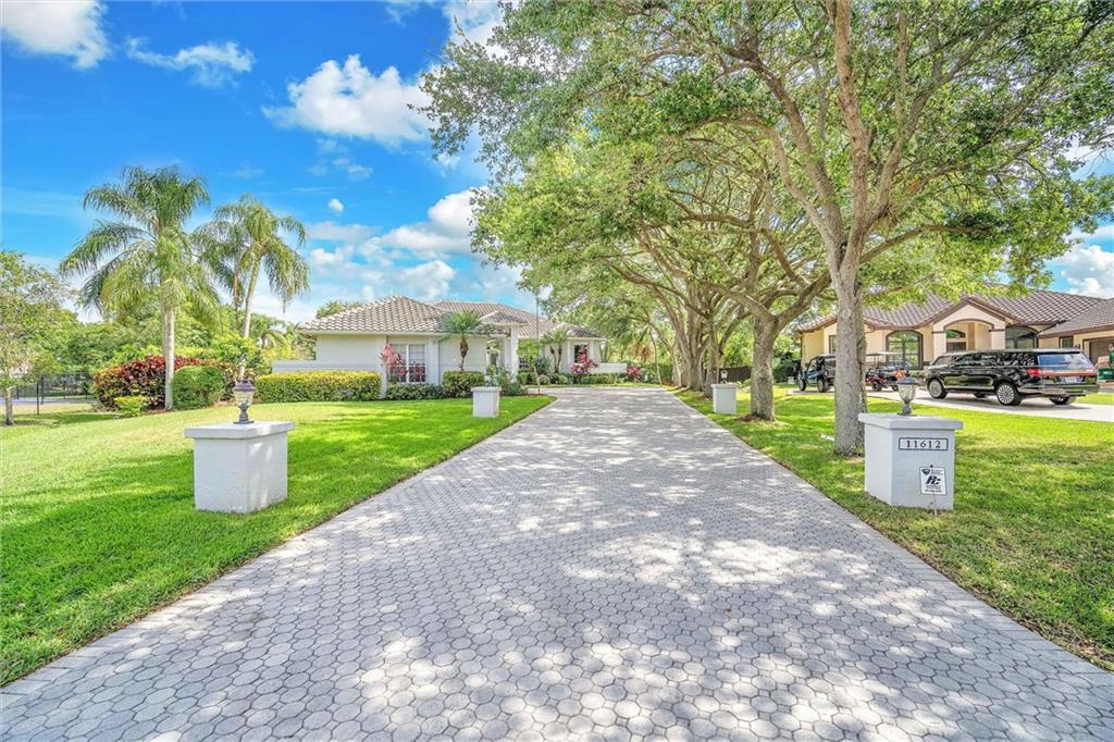 Welcome to your dream home in the prestigious Plantation Acres community! This stunning 5-bedroom residence sits on a large cul-de-sac lot. 5 bedrooms and 5 and a half bathrooms provide the utmost privacy and convenience for residents and guests. The large master bedroom features his and her walk-in closets, and the upgraded kitchen overlooks the breakfast nook, family room, and bar, making it perfect for entertaining. Step outside to the screened-in pool and spa and take in the gorgeous views of the private backyard. You'll love the added luxury of a sauna and basketball half-court, perfect for relaxation and recreation. Stay prepared for any weather with accordion shutters and impact doors. This home is perfect for a growing family or those who love to entertain guests.
