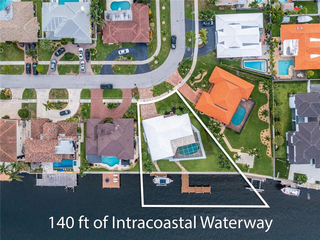 ONE OF A KIND RARE OPPORTUNITY!! Don’t miss this Direct Intracoastal home with 140' of frontage on the water. Home sits on an oversized lot with an Extensive Pier and Boat Lift. Hard to find unique location, with no across the water condo or homes. Updated kitchen and bathrooms. Enjoy beautiful sunrises from hard-to-find additional 564sf Covered outdoor living and dining area, along with 713sf screened enclosure. Home has breathtaking unobstructed views from all rooms in this lovingly maintained home, with large impact sliders leading out to covered patio. Plenty of room to add on or build new. Home was originally a 3br and can easily be converted back. Big two car garage, with built in storage cabinets. By appointment only and Listing Broker must accompany.