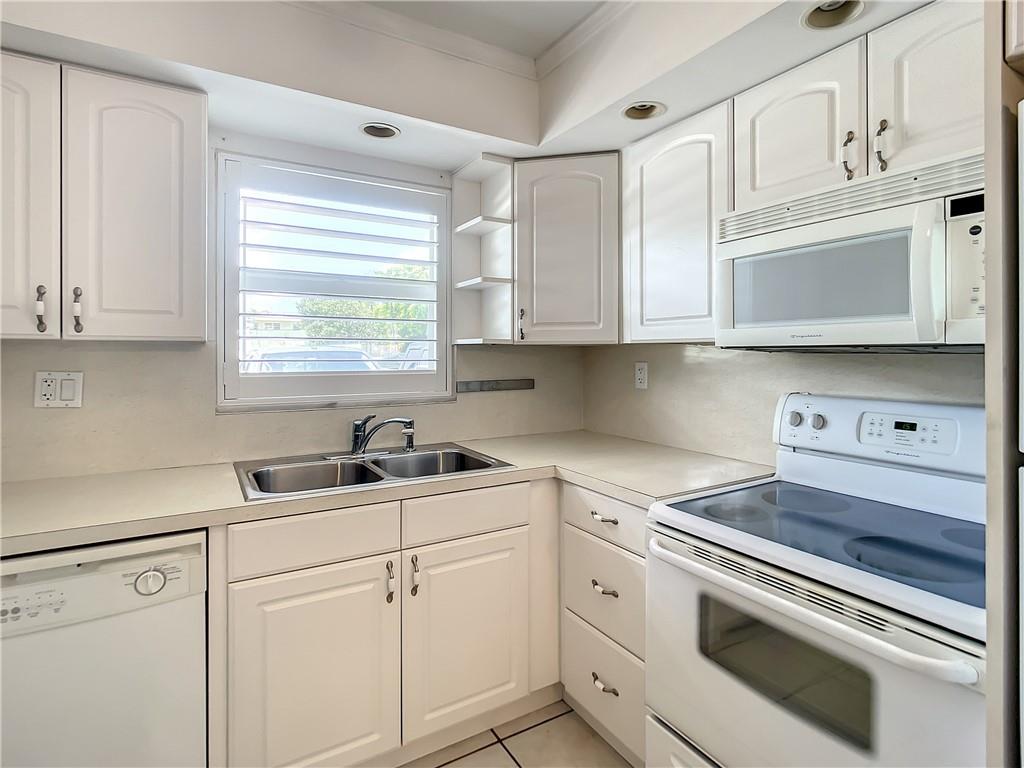 Walk to the beach for sunrise and watch sunset on intercoastal daily!  Condo is two blocks from beachfront access. Renovated 2 bed/2 bath with Huge closets and pantry!  Beautifully remodeled chic bathrooms with modern fixtures.  Large bedrooms with crown molding, smooth ceilings and cherry wood floors.  White Kitchen with crown molding, updated lighting and cabinets.  Impact windows and plantation shutters. Large screened front patio. New AC and electrical panel.  Boutique building with heated pool; 2 small pets OK; all ages welcome; rental after 1yr; Low HOA fees.  Two cars tandem and guest parking.  Close to pier, restaurants, 1 block to the lovely public Intercoastal Park and quick access to Atlantic or 14th St. bridges. ENJOY THE FLORIDA BEACH LIFESTYLE NESTLED BETWEEN THE  INTRACOASTAL AND ONE BLOCK FROM THE OCEAN. SPACIOUS GROUND FLOOR 2/2 CONDO.  LARGE SCREENED PATIO FOR ENJOYING YOUR MORNING COFFEE RENOVATED AND READY TO MOVE IN. NEW AC.  IMPACT WINDOWS. TILE FLOORS AND CHERRY WOOD FLOORS IN BEDROOMS.   YOUR NEW RESIDENCE OR VACATION RETREAT IS A SHORT WALK TO ALL THE FUN RESTURANTS, ENTERTAINMENT AND FISHING PIER OF POMPANO BEACH. 2 SMALL PETS ALLOWED.