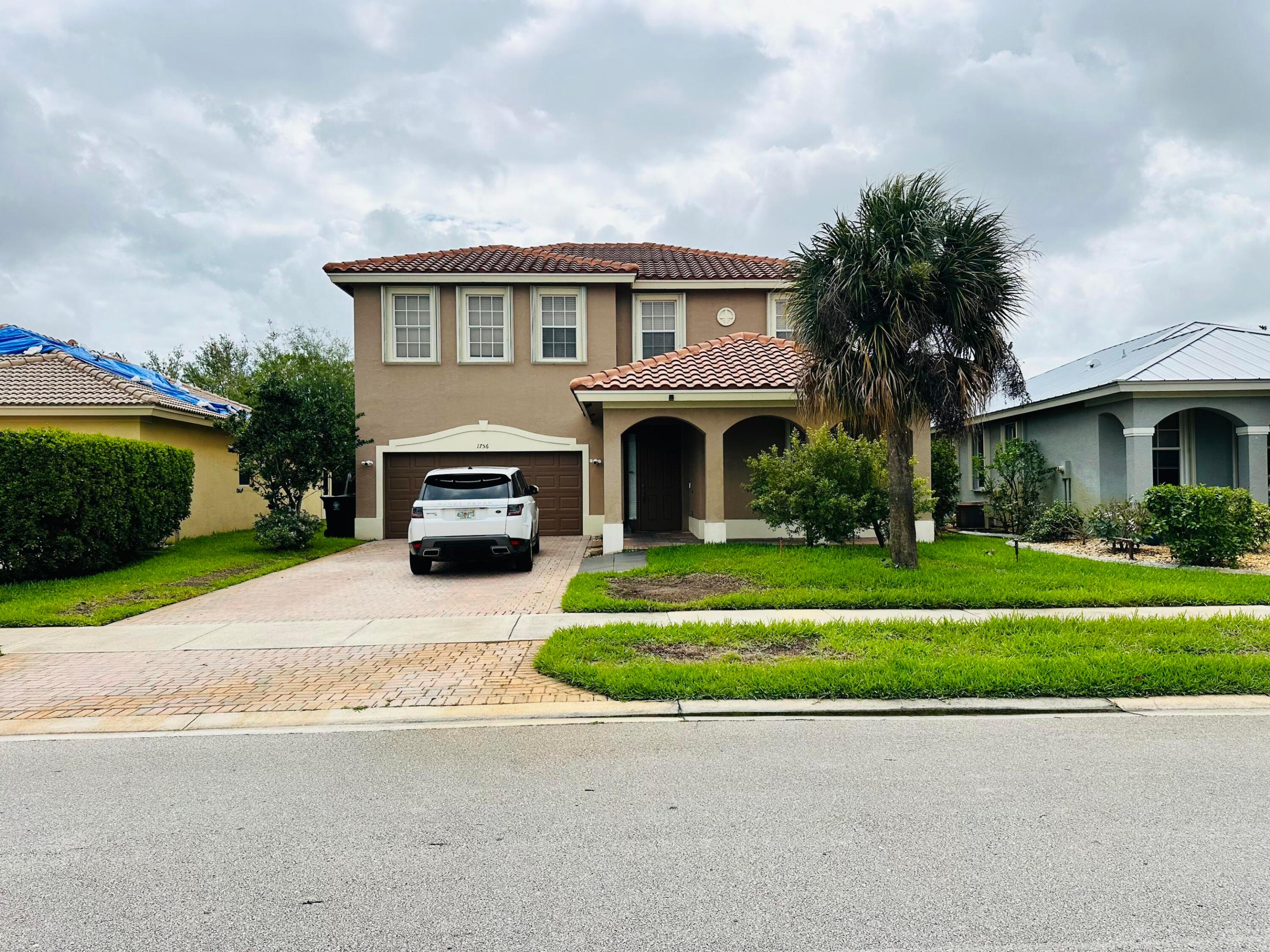 Don't miss this rare opportunity to own a stunning 2 Story home in the desirable Port St Lucie area. Nestled on a quiet street in the exclusive community of Newport Isles, this beautiful property offers the perfect blend of space, privacy, & luxury. Step through the single door entry into a soaring two-story foyer, with 2 story floor-to-ceiling heights in the living room. Designed for both comfort & style, this beautifully maintained home features new flooring, HURRICANE SHUTTERS, and a striking wood staircase.  4th bedroom is a huge closet but can be converted back to a bedroom.  This property is Ready to Move In!!!  BRING ALL OFFERS SELLER IS MOTIVATED!!!