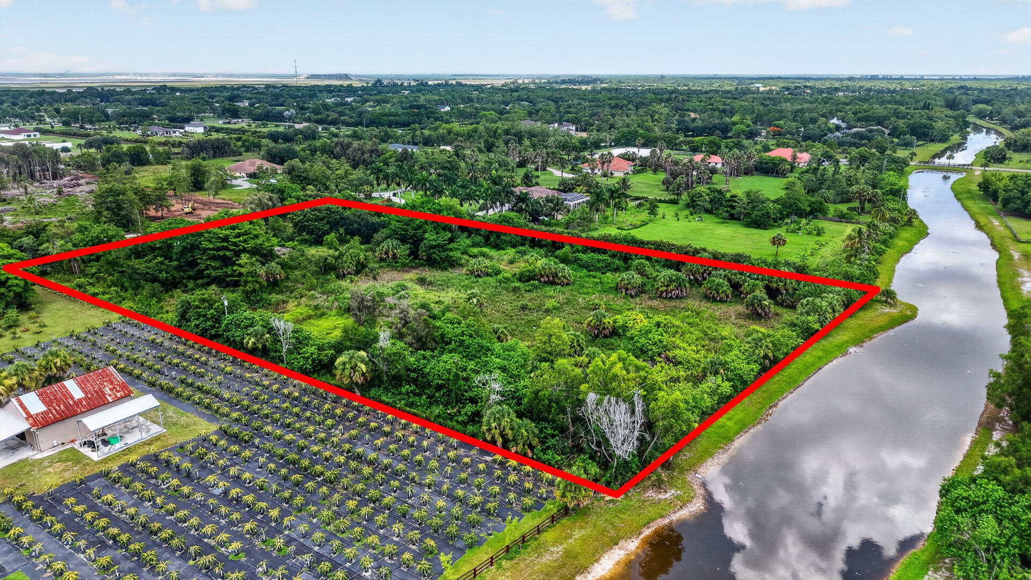 Build Your Dream Equestrian Estate on 5 Acres in Deer Run! Rare opportunity to own 5 picturesque acres in the highly desirable Deer Run community of Loxahatchee. Nestled on a quiet cul-de-sac with serene canal frontage, this fully fenced, buildable homesite offers the ideal setting for a luxury custom home, equestrian estate, or private country retreat. Designed for those seeking space and flexibility, this equestrian-friendly property provides ample room for a custom residence, barn, riding arena, paddocks, guest house, workshop, RV or boat storage, detached garage, resort-style pool, and expansive outdoor living areas. Whether you envision a modern farmhouse or a timeless estate, this exceptional parcel offers endless possibilities to create your ideal lifestyle.  Enjoy the privacy and tranquility of acreage living while remaining just minutes from Wellington's internationally recognized equestrian venues, top-rated golf courses, shopping, dining, parks, and major commuter routes. Surrounded by beautiful custom homes and open green space, this is an outstanding opportunity to build in one of Loxahatchee's most sought-after acreage communities.  Bring your builder and create the estate you've always imagined.