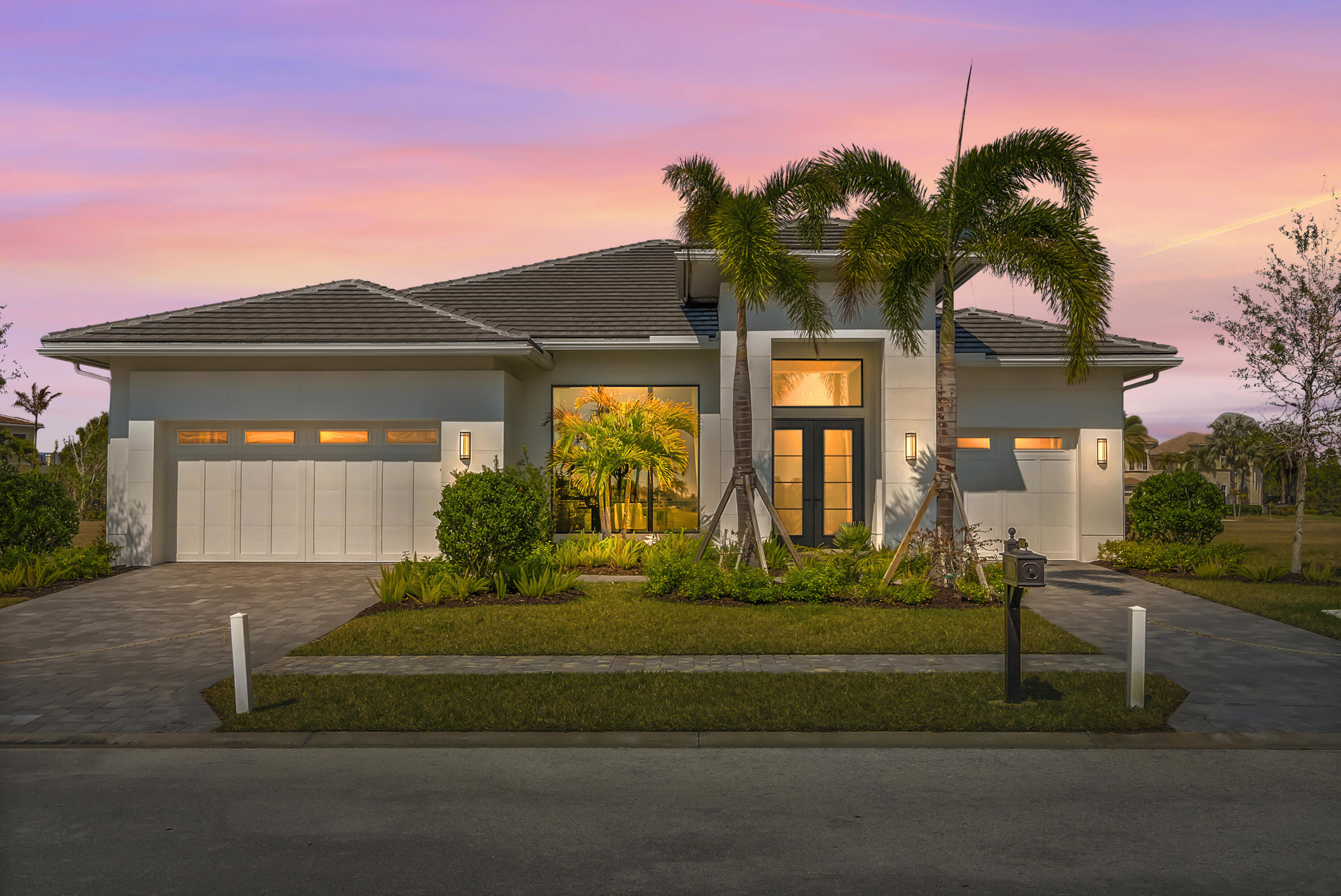 This coastal-contemporary semi-furnished home offers 3 bedrooms, 3.5 bathrooms and a 3-car split garage across 3,299 sq. ft. of air-conditioned space and 4,651 total sq. ft. The kitchen features a large center island with an extended breakfast bar, double-stacked white cabinetry, solid white quartz countertops, and premium Café appliances, including a 42'' built-in refrigerator, wall oven/microwave combo, gas cooktop, and a hidden pantry.  Soaring 12-ft. ceilings, a club room with wet bar and elegant 32x32 tile flooring throughout enhance the home's luxurious feel. The great room includes a built-in bar with upper and lower cabinetry and opens to a spacious lanai and pool deck with travertine pavers. The pool showcases a sun shelf and water feature.