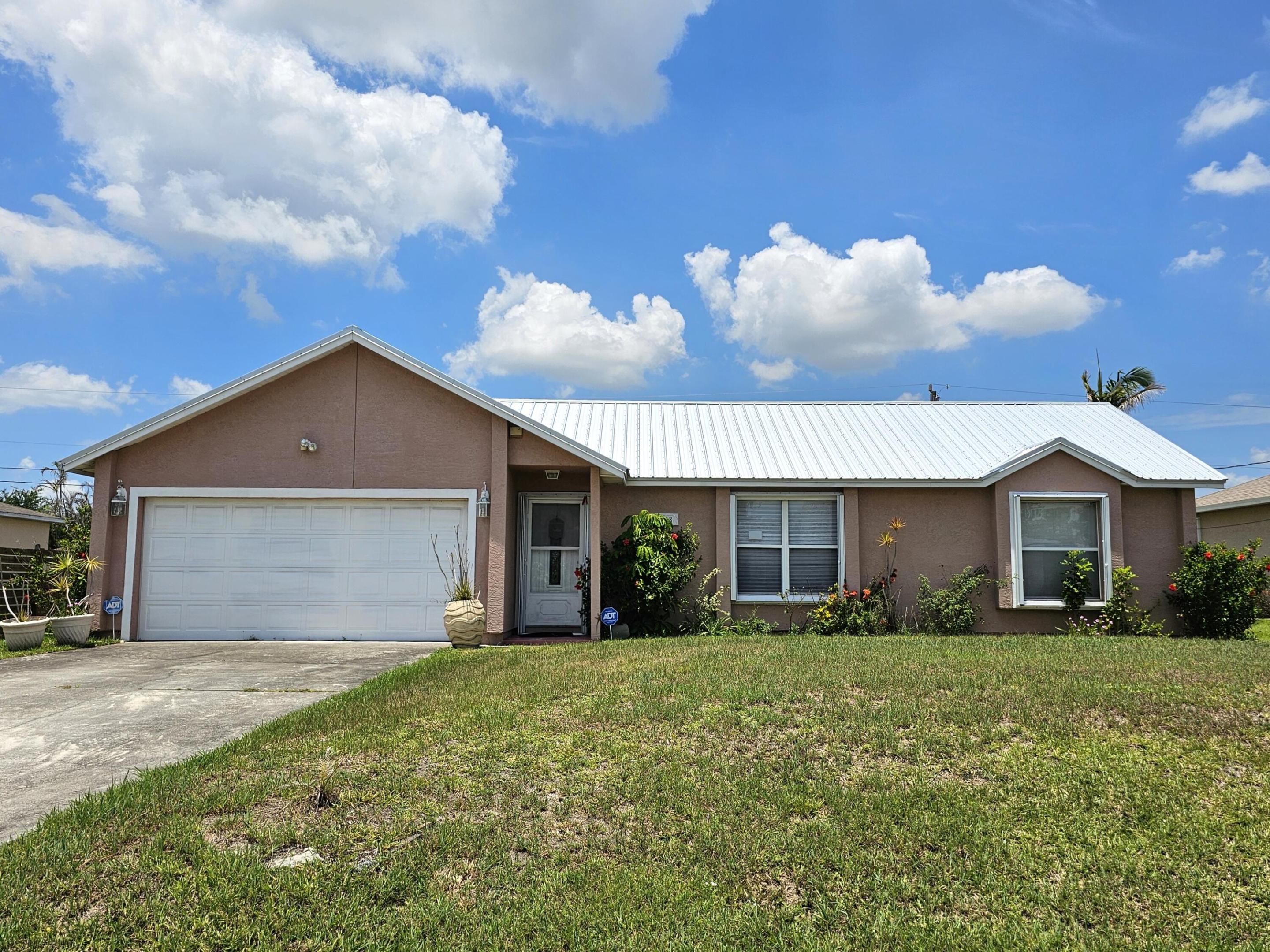 Welcome home to this well-maintained 3 B/R, 2 BA with a 2 car garage. Desirable split floor plan featuring 1,485 square feet of living space. This home offers separate living, dining, & family rooms, providing plenty of space for entertaining & everyday living. The dining & family living areas flow seamlessly to the spacious backyard, perfect for outdoor enjoyment. A cabana bath adds convenience & functionality. Recent upgrades include a 2023 metal roof & accordion shutters for added peace of mind. Don't miss this opportunity to own a comfortable home with room to relax both inside and out. Conveniently located close to I95, Turnpike & Crosstown Parkway for quick and easy commuting.  Close proximity to hospitals, A rated schools, parks, shopping and restaurants.