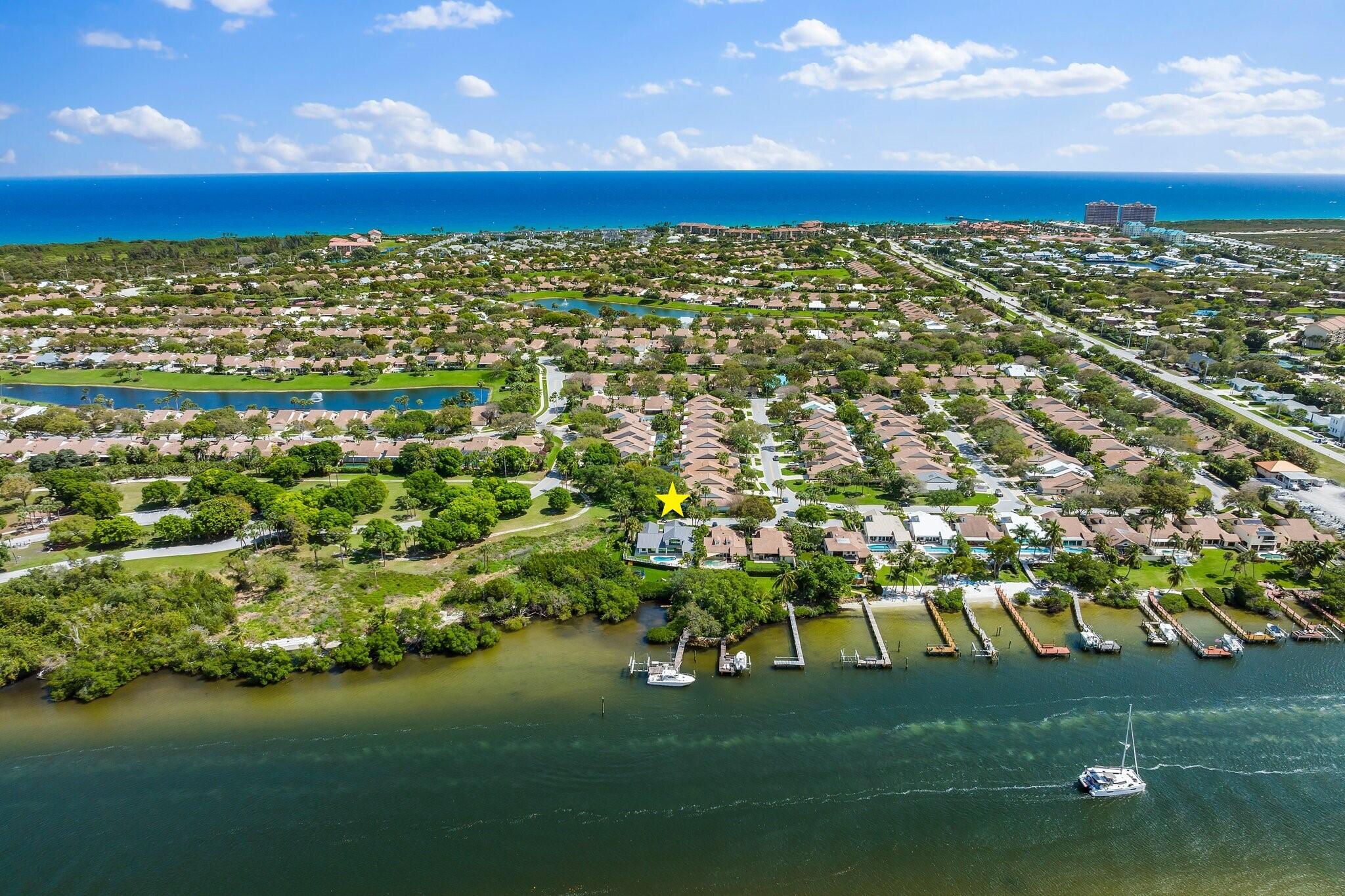 Directly on the Intracoastal, & less than 5 minutes from the Beach. A special & hard to find location! Tranquil home w/entertaining views of the Intracoastal & stunning sunsets. Effortless flow from the indoor to outdoor spaces makes everyday living or playing host easy. Travertine floors, custom cabinetry, marble counters, Miele, Subzero, Wolf appliances. All bedrooms are ensuite, plus wellness room & office. Master on main or upstairs, whichever you prefer. Guest wing could make inlaw suite w/sep entry. Impact glass makes lock & go easy! Enjoy the waterfront lifestyle poolside, boating, kayaking or simply head to the beach. Yacht dockage is a golf cart ride away at the Bluffs Marina. PBI Airport 30 to 45 min away. COMPLETE RENO W/ADDITION AND EFFECTIVE YEAR BUILT OF 2021 " CBS Home expanded and renovated down to the studs in 2020  2021, photos upon request
" All new drywall (Level 5), ductwork, mechanical systems (AC  3 zones), plumbing, electrical
" PGT Impact Windows, Doors, and French doors
" New standing seam  highest quality  level 4 metal roof to withstand 240 mph winds
" 80-gallon gas hot water heater the whole house except north guest wing - 40 gall electric hot water heater
" Icynene insulation  R rating of 3.7
" Sound proofed 2nd floor and all bathrooms throughout home
" Travertine & porcelain wood floors
" Phillip Hues lighting elements in Entry, Great room, Kitchen, Butler's pantry undermount lighting
" Custom plumbing fixtures
" All new travertine pavered exterior deck
" 500-gallon Propane tank currently serving the dryer, water heater and gas grill 
" Underground plumbing complete for generator and pool heater
" Freshly painted exterior
" All new landscaping in front, back and waterfront lawn spaces
" Wifi thermostat and home controls
" Security system via wifi and Arlo video monitoring 
" Custom staircase and railings
Kitchen
" Custom white cabinets with Lucite drawer pull
" Wolf Legacy Professional Induction Range & Professional stainless hood 


" Icemaker
" Slab marble island and counter tops
" Soft close cabinets, pots and pans drawer, full butler's pantry 
" Touchless kitchen faucet
" **Coffee station and Subzero refrigerator pullouts in the upstairs Master
HOA fees include:
" Lawncare and water for sprinkler provided for front and side yards not including the custom plantings
" Common areas, Pool, Cabana, Playground, Basketball courts, Tennis, Basic Cable, Manager on site