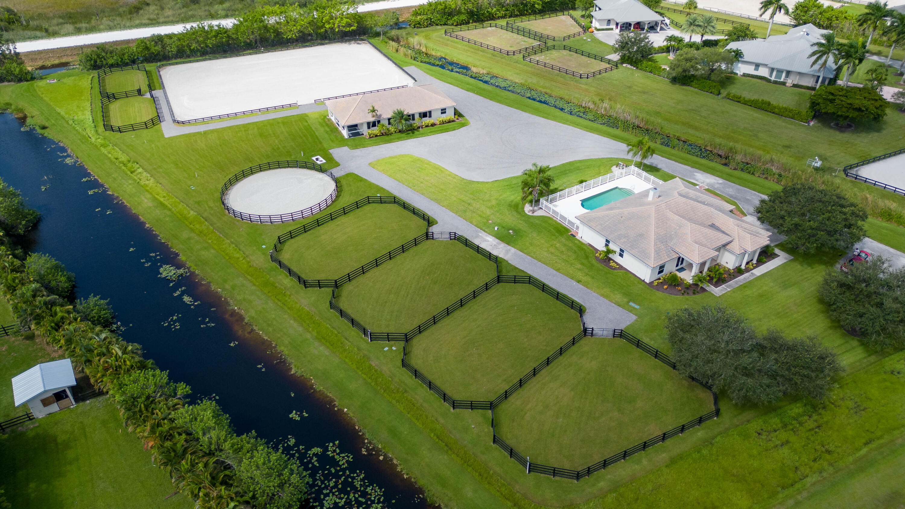 Welcome to this beautiful renovated equestrian property!
Conveniently located in the famous gated community of Palm Beach point.
This property offers a top-of-the-line equestrian facility just under 5 acres. The seller has renovated the property efficiently by moving the current arena to the rear of the property to provide ample space for parking and turning with the trucks.
The community authorizes 8 additional stalls for a total of 16 stalls. Sellers have an approved permit to extend the existing building which includes: 8 stalls, 4 apartments, 1 lounge, a storage room and a feed room.
Additionally, the beautiful 4-bedroom home has a lovely split floor plan with a large kitchen open. The saltwater swimming pool has been refurbished and equipment changed. Plans are in the documen