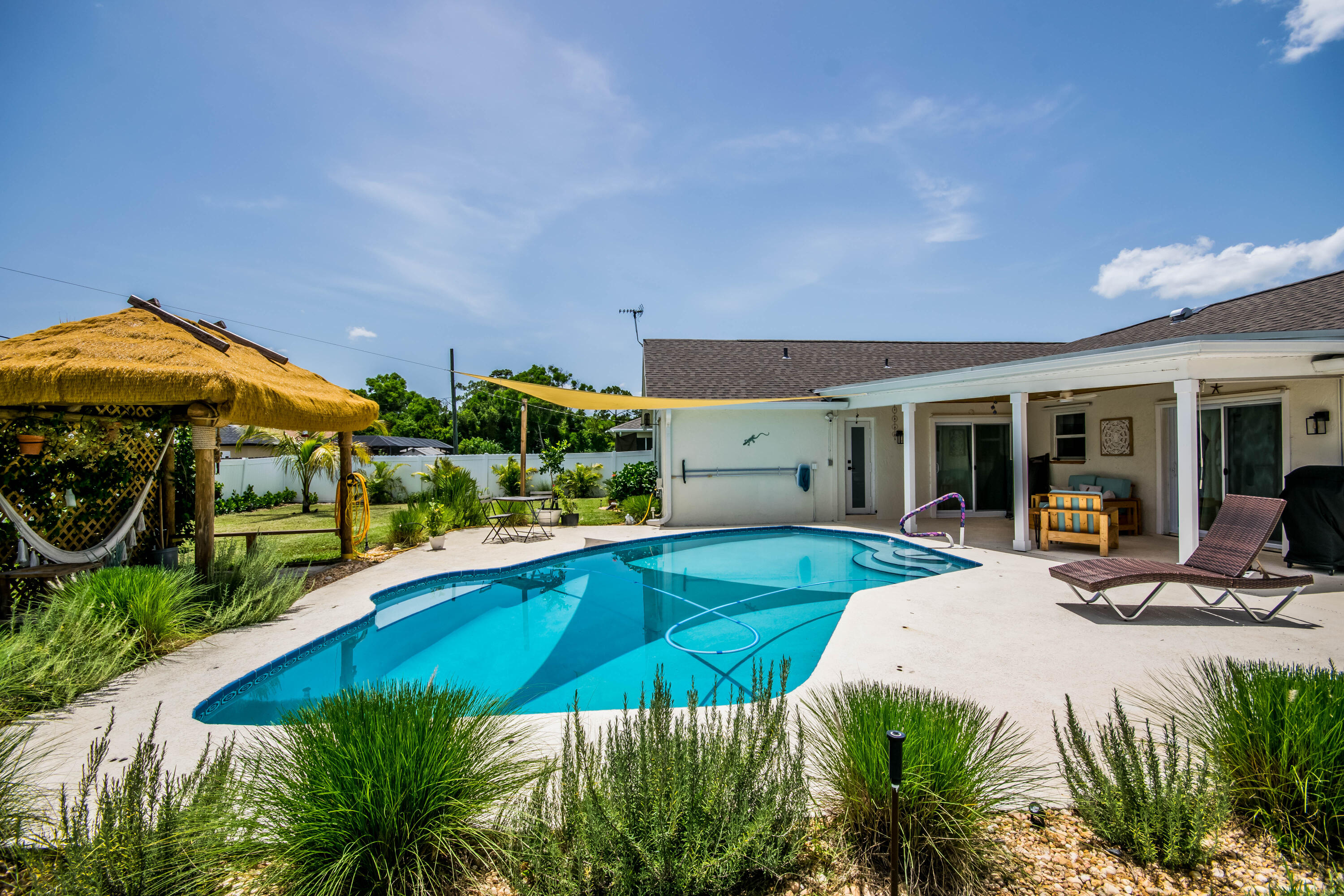 Must-see renovated 3-bedroom, 2-bath single-family residence with a nice sized fenced yard and private pool. The entire home has been beautifully updated with new flooring throughout, an updated kitchen featuring new cabinetry and appliances, and a stunning primary bathroom with a large walk-in porcelain and marble shower. Both the primary and guest bathrooms feature new vanities, with the guest bathroom offering a tub/shower combination.  Each bedroom includes a walk-in closet. Additional upgrades include recessed lighting throughout, smooth skim-coated walls, fresh paint and newer blinds throughout.  The covered patio features a beautiful tongue-and-groove wood ceiling and overlooks a private backyard with lush landscaping and a tiki hut—perfect for relaxing or entertaining. Conveniently located with easy access to Florida's Turnpike, shopping, grocery stores, restaurants, and more. All sizes are approximate and must be verified. Washer and dryer currently in the residence will be replaced.