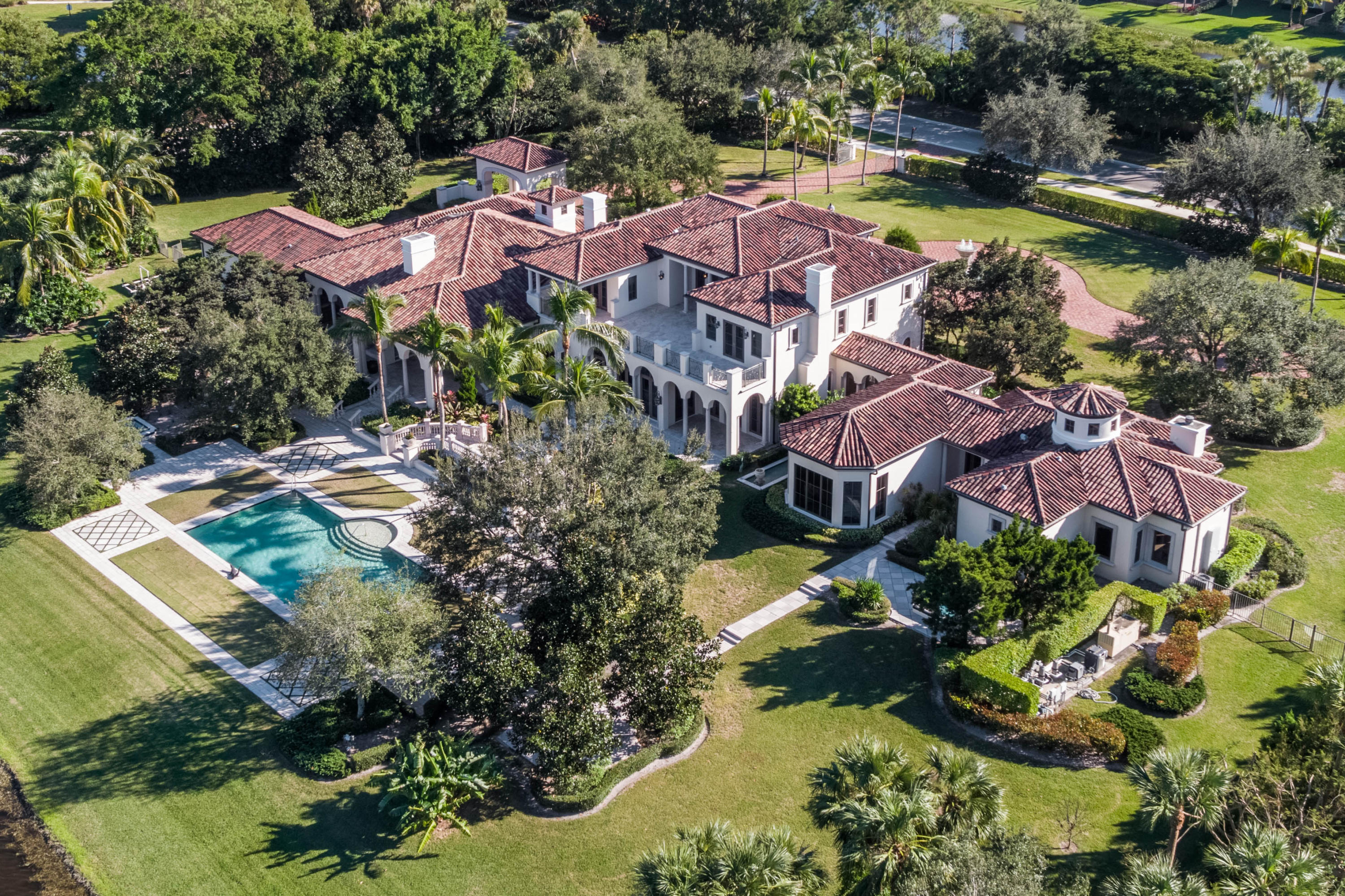 A rare opportunity to own this unique Frankel Infinity custom built 2.6 acre estate in the prestigious Stone Creek Ranch. Never before on the market this grand 6 bedroom 7.3 bath residence is located on a spectacular private lake lot and features over 17,000 total square feet. Throughout the serene and sprawling grounds you will find water features including flowing pathways, cascading waterfalls and a magnificent stone fountain at the courtyard roundabout. A gas lit private double gate welcomes you as you drive onto the property and pass through the Porte Cochere to the 5 car garage and courtyard space.A relaxing custom water feature flows under the dreamlike corridor leading to the Master Bedroom Oasis. Steps from the aster retreat is a one of a kind hand built and crafted office feature custom built-ins and detailed moldings. Beyond the veranda a magnificent colonnade aligned portico with an outdoor gas fireplace and built in summer kitchen raises the bar for opulent outdoor entertaining. Other extravagant features include the oversized gourmet kitchen with top of the line Viking and Wolf appliances plus a built in Miele espresso machine. A Crestron home automation lighting system and exterior camera security system make this elegant estate a smart home. A top of the line professional media room is the perfect place to watch a movie or a game or enter the club room featuring a wet bar fire, place and billiard table, a perfect escape from life's daily grind. A private elevator whisks you to the expansive 2nd floor which boasts an additional 4 bedrooms each with their own balcony and ensuite bathroom and walk in closets. An abundance of natural light illuminates the upstairs loft with access to the large marble slated veranda overlooking the striking grounds. Crema Marble and Hardwood floors, 5 Gas fireplaces, 2 Heated outdoor Spas Impact Glass and so much more. Stone Creek Ranch is an exclusive 37 estate home community in an idyllic setting with more than 70 acres dedicated to park like green spaces and lakes. Nestled on one of the best lots in the community, this home is the perfect mix of timeless elegance and transitional luxury, an estate home for the ages.