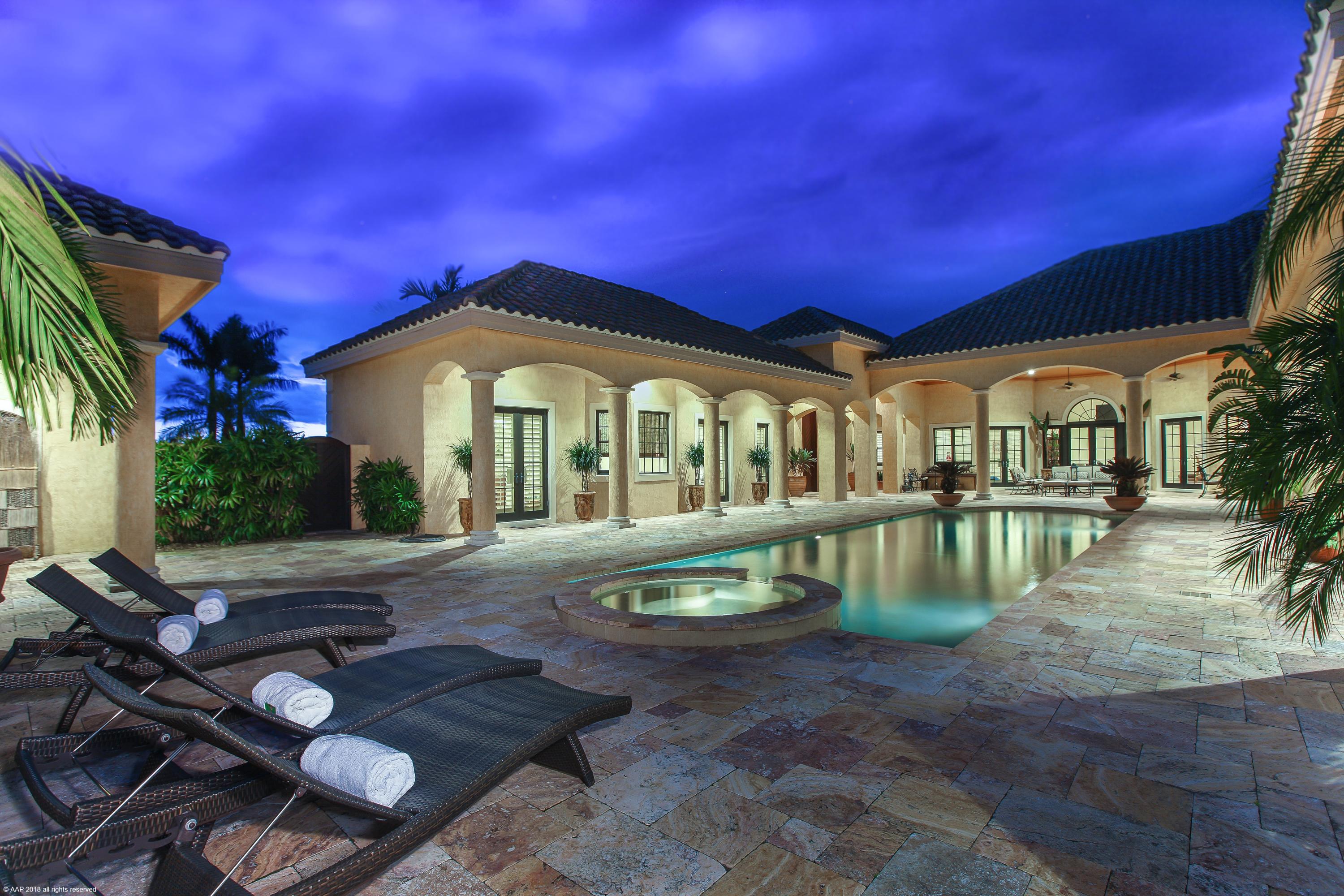 Location, location, location. Pristine estate home with adjacent equestrian center is a breathtaking property. With 5 bedrooms and 6.5 baths, two fireplaces, impact glass, and generator, the bright home exudes comfort and elegance. The courtyard features an oversized lap pool, heated spa, and guest house all with marble decking and an entertainment area with outdoor shower. The residence and 14-stall center-aisle barn sit on two lots spanning 10.78 acres Overlooking a new GGT arena, grass riding field, and luscious paddocks. The barn features a roomy owner's lounge, two studio apartments and manager's quarters. Located by the bridge to Grand Prix Village, just a short hack to Palm Beach International Equestrian Center.