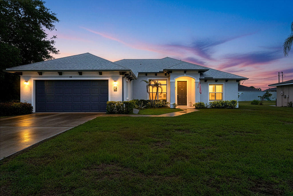 Location, location, location! This stunning 4-bedroom, 2-bathroom home offers the perfect combination of convenience, security, and modern upgrades. Ideally located near the turnpike, I-95,St. Lucie West, and Tradition. Enjoy ultimate peace of mind with hurricane impact windows, ADT security system, and wired cameras installed both inside and outside the home. Step inside to find elegant tile flooring throughout and premium quartz countertops in the kitchen, bathrooms, and laundry room. Designed for both comfort and functionality, this home features plantation shutters, upgraded closet systems, custom pantry shelving, and modern wall switches with timed lighting. Today's buyers will appreciate the substantial improvements. Turnkey and ready for its new owners-  come tour today! All sizes are approximate. Buyer and buyer's agent to verify.