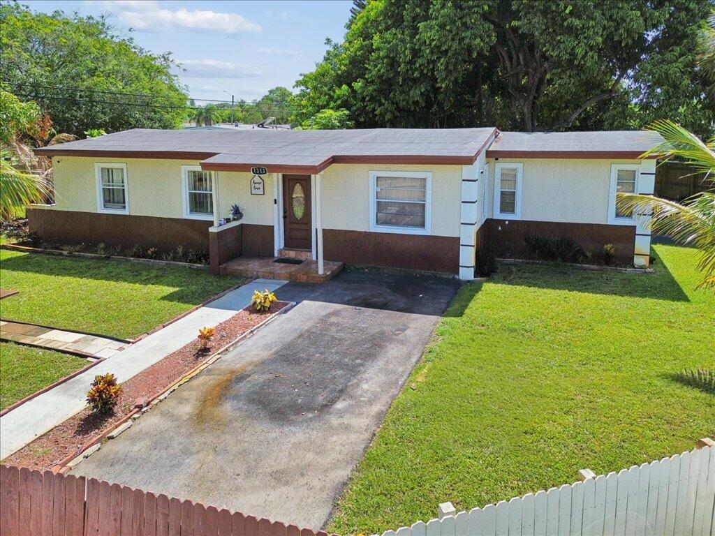 Looking for a 4-bedroom home with no HOA and an oversized lot near downtown Fort Lauderdale? This well-maintained 4-bedroom, 2-bath residence offers an updated kitchen, spacious outdoor living, and convenient access to parks, dining, shopping, and South Florida attractions. This inviting home features a beautifully updated kitchen with sleek granite countertops, ample cabinetry, and a functional layout designed for comfortable everyday living and entertaining. Step outside to a private backyard surrounded by lush tropical landscaping and mature fruit-bearing trees, creating a peaceful setting to relax or gather with family and friends. Conveniently located near Roosevelt Gardens Park, Secret Woods Nature Center, Sunrise Boulevard, Wilton Manors, Las Olas Boulevard, Fort Lauderdale Beach, and Hugh Taylor Birch State Park, this home offers the perfect combination of comfort, convenience, and the South Florida lifestyle with no HOA.