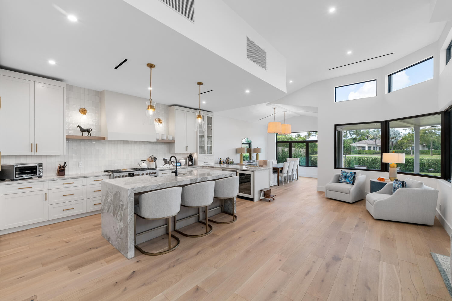 Located behind the manned security gate of the exclusive Palm Beach Polo Country Club. This stunningly renovated 3-bedroom, 3-bathroom home offers a blend of modern elegance and functional design, all while overlooking the picturesque Cypress Golf Course and featuring a serene lake view. With its open floor plan, high ceilings, and wood floors throughout, this home exudes both style and comfort. The kitchen is a chef's dream, showcasing custom cabinetry, marble countertops, and a farmhouse sink. It comes fully equipped with all new appliances, including a gas range and a Fhiaba refrigerator. The attention to detail extends to the sleek plumbing fixtures and new HVAC unit with stylish lineal AC vents installed in the ceiling.
