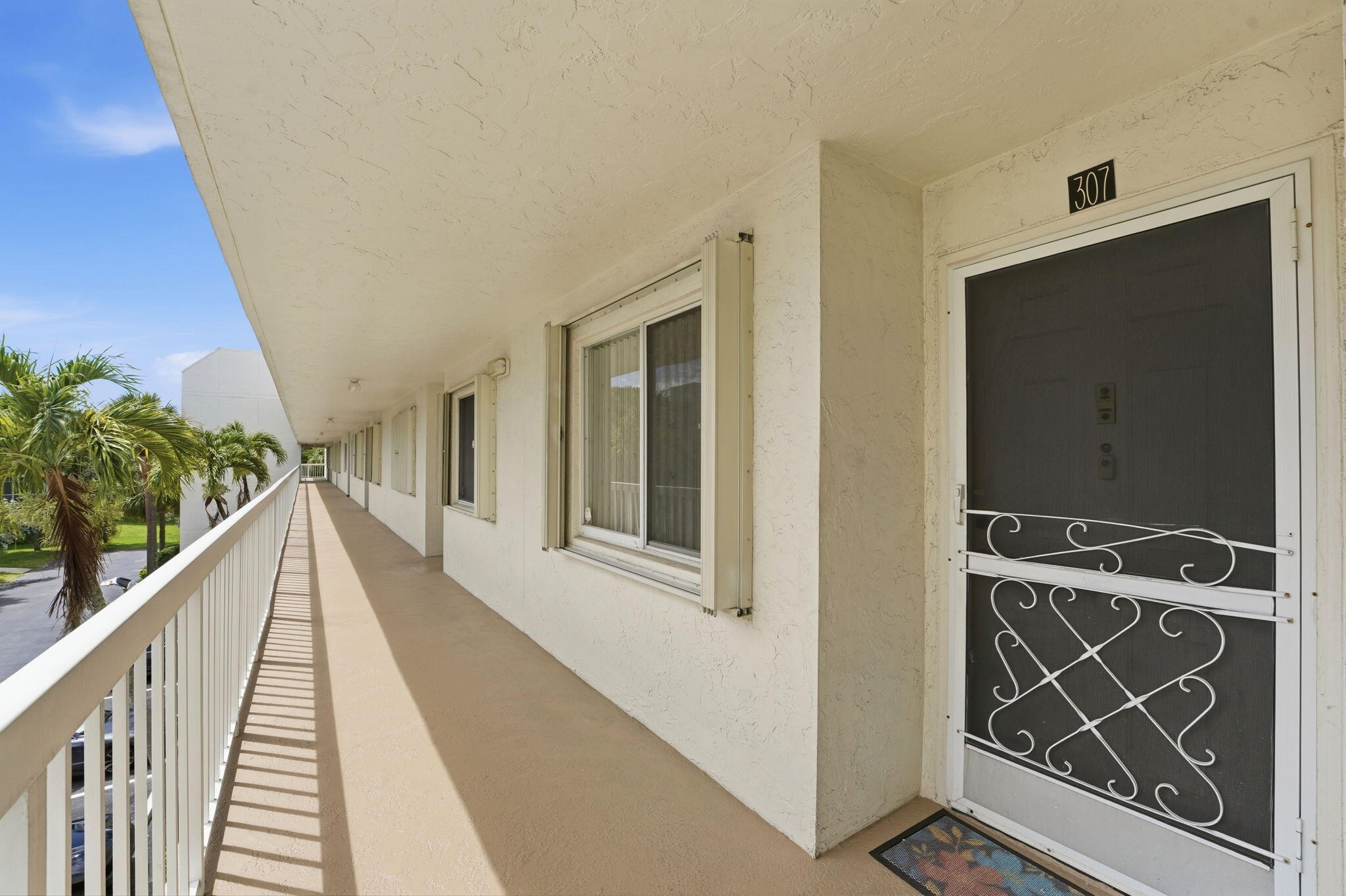 Welcome home to this bright and spacious 2-bedroom, 2-bathroom condo offering beautiful lake and fountain views from its desirable third-floor location. The thoughtfully designed floor plan features an eat-in kitchen with two large pantries, providing plenty of storage and functionality. Both bedrooms have been updated with luxury vinyl plank flooring, and the air conditioning system was replaced in 2023.  Relax on the screened balcony while enjoying the tranquil water views and gentle sounds of the fountain, or close the sliding glass doors to create additional living space. Accordion shutters offer added convenience and storm protection.  Residents enjoy access to a community clubhouse, resort-style pool, meeting and party room with kitchen facilities, and ample guest parking.  Ideally situated near Okeeheelee Park, you'll have easy access to walking and biking trails, golf, kayaking, and a wide variety of outdoor activities. With convenient access to both Florida's Turnpike and I-95, commuting and exploring South Florida is a breeze.