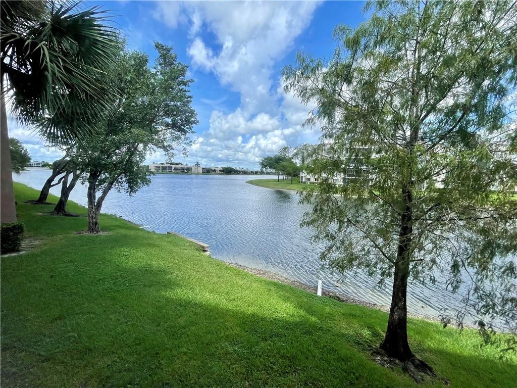 Bright and Sunny End Unit! 2-Bedrooms, 2-Bathrooms and Enclosed / Screened Porch Overlooking Wide Water View. Huge Walk-in Closets in Both Bedrooms Plus an Oversized Pantry Closet in the Hallway. Great Layout with Both Bedrooms having Patio Access. Tile Throughout Most of the Unit with Carpet only in the Living Room. Full Sized Washer/Dryer in Utility Room off Patio. No Rentals in this Building. Ashmont Condo is Located in Kings Point which Offers ALL the Amenities including Active Clubhouse, Courtesy Busses and a Huge Theatre! Association States 55+