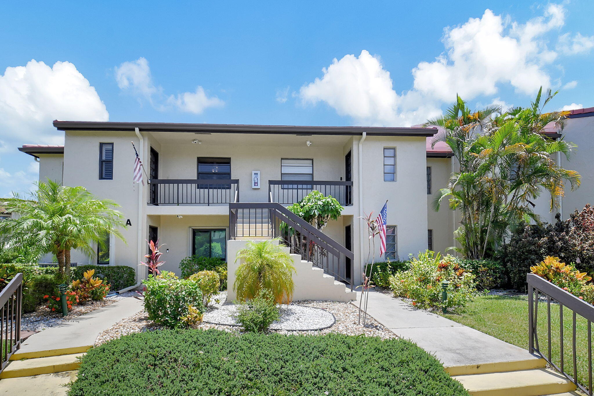This beautiful 2nd floor corner unit in Fairways Green, Boca Raton, is in a secure 55+ community with 24-hour manned gate access. It features 3 bedrooms and 2 bathrooms in a split floor plan, with impact windows throughout. The open living room, dining room, kitchen and patio offer peaceful lake views. The unit features several recent updates, including new 14-inch attic insulation to keep it cool during Florida's hot summers. It also boasts a brand-new electric box, AC system, and hot water heater. Inside, you'll find crown molding, baseboards, new closet doors, and a wet bar with a wine fridge, top and bottom wine racks, and a bar sink. New fans and light fixtures are installed throughout, and both bathrooms have been completely renovated. The home features tile flooring in the main areas, carpeting in the bedrooms, and charming plantation shutters. The enclosed back patio, complete with glass sliding doors, roll-down shutters, and large shiny tile floors, offers serene views of the tranquil lake and is air-conditioned for added comfort. The remodeled kitchen boasts sleek stainless steel appliances, plentiful cabinets and pantries, new flooring, and a chic 2-seat bar area. The kitchen is beautifully designed with grey cabinets, silver handles, a matching stainless steel sink faucet, and a grey-and-white backsplash that complements the countertops. The master bedroom features 2 walk-in closets 1 in the bathroom hallway and another within the master bedroom itself a linen closet, and a single sink vanity with a powder area. The separate toilet area includes a walk-in shower with elegant floor-to-ceiling wood-look tile and glass shower doors. The 1st guest bedroom, located towards the front of the unit, features an oversized closet and a window overlooking the front of the home. The unit also has an in-unit stackable washer and dryer located in the guest bathroom. The 2nd guest bedroom, situated at the back for added privacy, includes sliding doors that lead to the back patio, offering tranquil lake views. The guest bathroom has been fully updated, featuring a walk-in shower with tiled walls and ceiling, as well as a single vanity. Boca Lago, aptly named "mouth of the lake," is a picturesque community comprised of 8 condo communities, a country club, and a golf course set among 29 lakes. Residents enjoy spacious villas, townhouses, and apartments with views of either the lakes or the golf course. Conveniently located near shopping, dining, parks, highways, and Boca Raton's stunning beaches and downtown entertainment, The Fairways of Boca Lago offers a friendly and relaxed lifestyle. This vibrant 55+ community of 298 units features 2 delightful pools with Wi-Fi, a clubhouse for meetings and gatherings, and a Social Club that hosts various entertaining activities and events. The dedicated Board of Directors, on-site management, and maintenance staff ensure that your experience in this community is both relaxing and enjoyable.