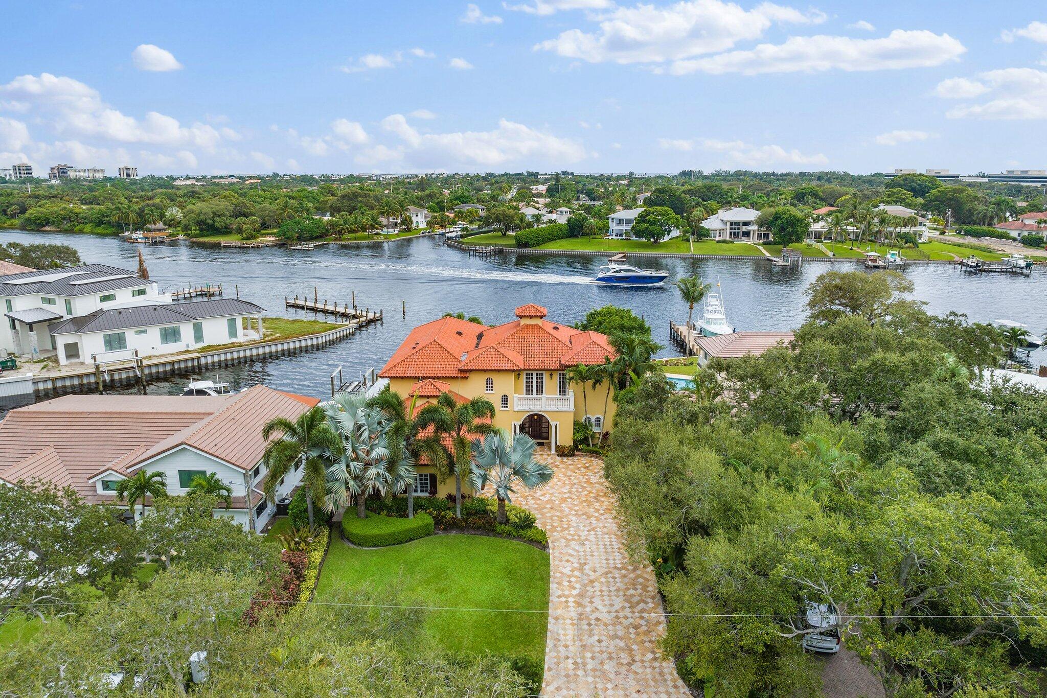 Boaters Paradise: deep water, no fixed bridges, no wake zone, between Jupiter Inlet and Lake Worth Inlets, as close as you can get to the Bahamas.  Wide water views from every bedroom.  Saturnia marble floors, Brazilian cherry flooring, faux finishing, crown molding & high ceilings throughout. A true chef's kitchen with 48'' Jenn air fridge & granite counters. All bedrooms are ensuite. Balcony runs the entire second floor with access to each bedroom. Two car lifts hold five cars in a/c garage. Travertine driveway & pool terraces. Oversized covered loggia & pebble-tec salt water pool & spa make this property an entertainers dream. Built in Wine closet. Mature landscaping. New 25,000 lb boat lift with underwater dock lights. One of the most premier lots on the intracoastal. No HOA. One of the most premier lots on the intracoastal.  55 Nautical Miles to the Bahamas.  No HOA  short term rental is an option for investment.  Sold turnkey with furniture if desired.
