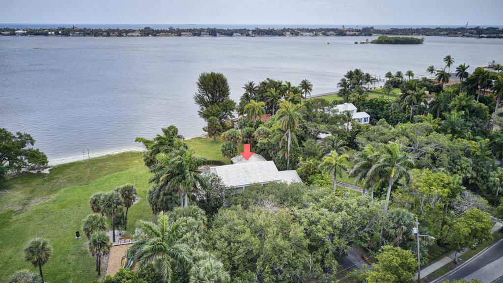 Sensational direct waterfront property in desirable Prospect Park on over a half-acre of land! Private beach and oasis alongside the Intracoastal with ability for a dock to be built. Enjoy Panoramic and Unobstructed views of the Intracoastal and Palm Beach. This non landmarked home and property allows endless opportunities for development and renovation. 
Colonial Revival home featuring an elegant floor plan including a formal dining room and breathtaking views of the Intracoastal perfect for entertaining. Enjoy water views from the great room, family, kitchen, and game room. The main retreat boasts spectacular views of the Intracoastal and a spacious balcony.