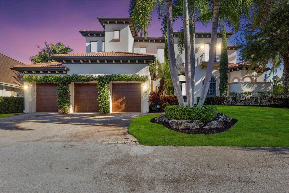 Embark on a coastal living experience at 825 Tropical Circle, an extraordinary bayfront residence designed for an unmatched waterfront lifestyle and captivating downtown views. Crafted with meticulous attention to detail in 2010, this 6,000 sq. ft. coastal sanctuary seamlessly integrates indoor and outdoor spaces on a private 20,000 sq. ft. Point Lot, boasting 122 feet of Open Bay. Immerse yourself in the allure of Sarasota Bay with cutting-edge dock featuring shore power, and a boat lift—complementing the serene surroundings. This elegant abode offers four to six bedrooms, 4 full plus 2 half-baths, and high-end finishes throughout, including a Gourmet Chef's Kitchen with Sub Zero, Fisher-Paykel, Wolf Gas Range, and Bosch appliances.
