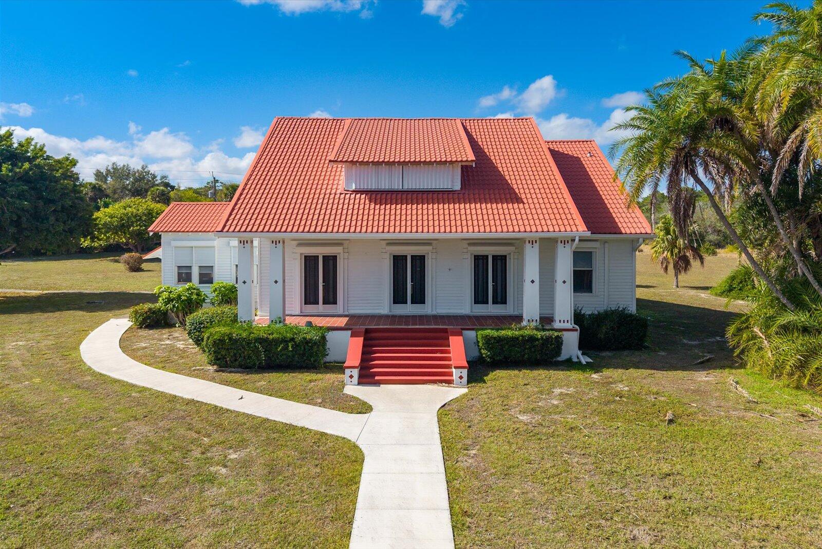 6BR Historic Riverfront Estate | 13.88 Acres | Indian River Drive, Fort Pierce  Built in 1922 and held by the same pioneer family for more than 104 years, this riverfront estate spans 13.88 private acres overlooking the Indian River. The residence was constructed using select old-growth wood materials shipped from Pennsylvania, reflecting notable craftsmanship and enduring quality. Interior features include plaster walls, rich wood floors, volume ceilings, detailed millwork, and stained glass interior doors. Expansive windows frame river views and fill the home with natural light.  Mature live oaks canopy the rear acreage, creating privacy and an unmistakable Old Florida setting. A historic barn constructed of Miami-Dade pine remains on the property, reflecting its agricultural heritage.