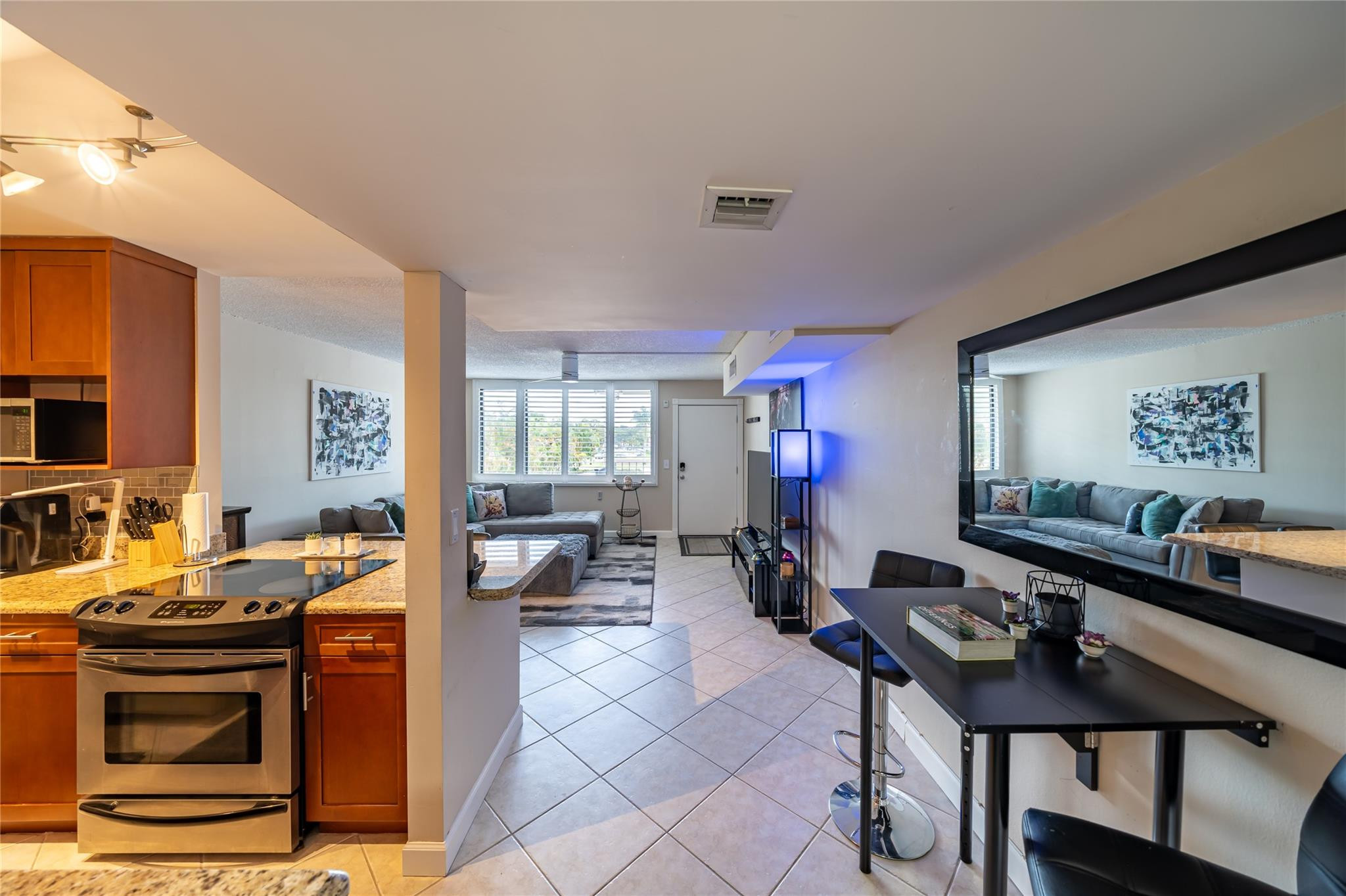 Immaculate corner unit condo, boasting incredible features. The layout is thoughtfully designed, creating a spacious feel within the cozy unit. Living room receives ample sunshine, impact windows & plantation shutters that add both style & functionality. Open kitchen with granite countertops & stainless-steel appliances. Large master bedroom with generous closet space. This secluded corner location provides privacy & tranquility, with easy access to the parking lot. 40 yr recert completed, included exterior painting, stucco, walkways, security cameras, outside lighting, pool and pool deck. Max 2 dogs allowed, combined total weight not to exceed 65 lbs. Building has fitness center, bike racks, & common area laundry.