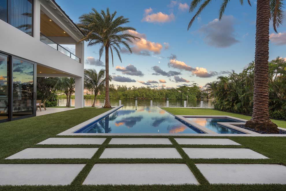 This Coastal Contemporary Waterfront Estate is located on a half-acre lot along the Intracoastal Waterway in the heart of East Delray Beach. Situated in the highly desirable Palm Trail neighborhood, the property measures 100 feet of width by 200 feet of depth making it one of the largest properties in East Delray. The rear of the estate faces east and overlooks a four-acre nature preserve, providing an unparalleled degree of serenity and privacy. Boaters will appreciate the brand new 80-foot concrete dock and no-wake zone, which allows convenient and secure dockage in your backyard. Voyages to the ocean are easy Boynton Beach and Boca Raton Inlets nearby. Furnished by Leighton Design Group, the residence features some of the finest finishes and attention to detail the industry offers. This Coastal Contemporary Waterfront Estate is located on a half-acre lot along the Intracoastal Waterway in the heart of East Delray Beach. Situated in the highly desirable Palm Trail neighborhood, the property measures 100 feet of width by 200 feet of depth making it one of the largest properties in East Delray. The rear of the estate faces east and overlooks a four-acre nature preserve, providing an unparalleled degree of serenity and privacy. Boaters will appreciate the brand new 80-foot concrete dock and no-wake zone, which allows convenient and secure dockage in your backyard. Voyages to the ocean are easy with the Boynton Beach and Boca Raton Inlets nearby. Furnished by Leighton Design Group, the residence features some of the finest finishes and attention to detail the industry has to offer. At the gated entrance are two 50-foot historic strangler fig trees that set the stage for the motor court and entry to this grand estate. The front door opens onto an expansive living room with views across the waterway to the nature preserve. The open floor plan allows each room to flow effortlessly to the next while the abundance of windows provide plenty of natural light and stunning views of the pool, landscaped grounds and Intracoastal. The expansive living and dining room feature an entire wall of pocket impact glass sliders that showcase the water views and open to the outdoor loggia and infinity edge heated pool and spa. The gourmet kitchen offers top-of-the-line appliances including Sub-Zero refrigerator, two Sub-Zero wine storage columns, Wolf range with double oven and custom ventilation hood, Wolf microwave drawer, and two Miele dishwashers. The kitchen also has custom floor to ceiling wood cabinetry, natural marble and quartz countertops with waterfall edges, two kitchen islands with two sinks and oversized walk-in pantry with built-in shelving. The spacious family room is open to the kitchen and features vanishing corner sliding glass doors that open to two separate loggias and the pool. The clubroom is separated from the living room by a two-sided gas linear fireplace. Additionally, the office is located off the clubroom with a full bath, closet and access to a separate one-car garage making it also a perfect fifth bedroom, staff quarters or guest suite. Completing the first floor are a spacious laundry room and mudroom with extra storage provided between a three-car garage and the kitchen. The second floor features three wings â€“ one for the master bedroom suite, the second for guest rooms and the third a private entry to an expansive multipurpose suite. The spacious and private master wing features vaulted ceilings, morning bar, his-and-her walk-in closets and master bath with dual sinks, freestanding soaking tub and separate shower. It enjoys a private covered balcony with outdoor natural gas linear fireplace and endless views of the grounds and waterway. The guest wing features three suites â€“ two are guest rooms with en suite baths and the third a VIP suite with vaulted ceilings and freestanding soaking tub. All three bedrooms offer walk-in closets and private access to an open balcony with views of the pool and waterway. The second floor also features a separate covered balcony off the guest room hallway, a second laundry room and a bridge to the multi-purpose suite that can serve as a gym, theater, artist studio and/or additional guest quarters with fully equipped plumbing. The exterior features are enhanced by two outdoor loggias with ample space for outdoor living and dining areas and are complete with summer kitchen and cabana bath. Open terraces surround the 40-foot infinity edge heated pool with spa and salt generator, all of which are Wi-Fi enabled. Designed to perfection and built to the highest of standards, custom features include extensive millwork, wide plank white oak floors throughout, custom built-in cabinetry, wood window sills and full wood casings, Level 5 smooth drywall finish, smooth stucco finish, salted concrete slab and artificial turf driveway. All baths include wood cabinetry, natural marble or quartz countertops, mudset marble or Italian porcelain tile flooring and wall tile, and frameless glass shower enclosures. Additional features include privacy wall and electric sliding gate entry with video monitoring, security system with motion detection, security camera system with Wi-Fi integration, linear diffusers for entire home, LED lighting, Lutron screwless wall plates, home automation system with Android and Apple device integration, Category 6 and RG-6 cable, low e impact doors and windows, generator, and four-zone air conditioning system with Nest Wi-Fi thermostats. Designed by award winning architect Richard Jones and developed by Azure Development, a well-known luxury homebuilder with a 30 year history in South Florida, this contemporary masterpiece was created to showcase the stellar water views and expansive grounds. From start to finish, this waterfront estate is absolutely spectacular and is truly one of a kind. Home is being sold furnished by Leighton Design Group.