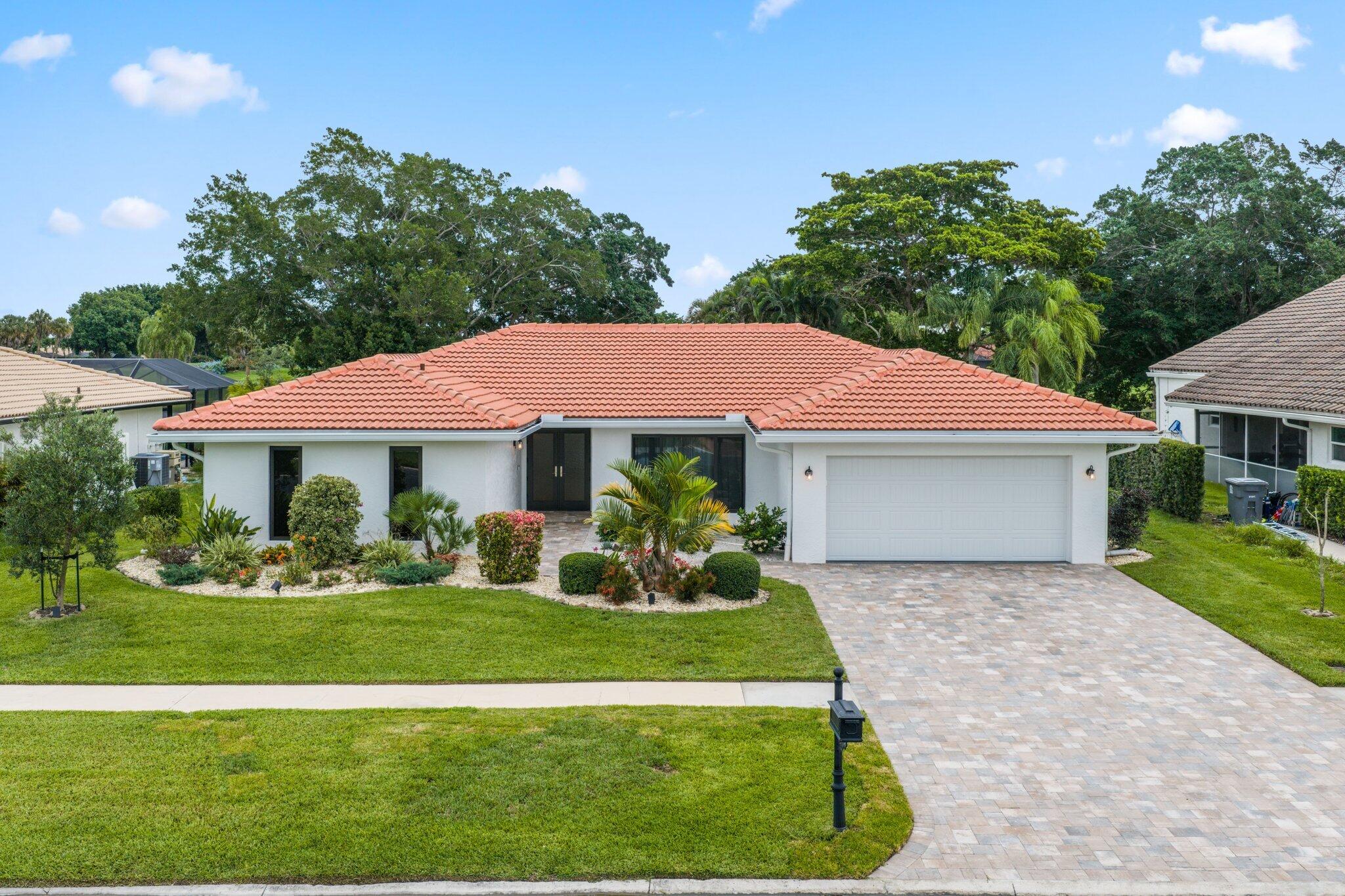 Immaculate lakefront pool home with stunning golf views in Boca Greens. This fully renovated 3-bedroom, 2-bath residence showcases large-format Italian porcelain tile throughout (including the garage), custom maple cabinetry, quartzite countertops, Bosch appliances, beautifully updated baths and upscale finishes throughout the home. Impact sliders fill the home with an abundance of natural light and open to a spacious covered patio and marble pool deck overlooking the lake and golf course. This home is where functionality meets comfort and luxury lifestyle. Major improvements include a 2024 roof, impact windows and doors, insulated impact garage door and new motor, updated electrical panel, new A/C and water heater, extended driveway pavers, meticulous landscaping, and much more.  Boca Greens is a guard-gated community with 586 single-family homes set within a beautiful park-like environment featuring walking paths lined with shade trees, lakes, and park benches. Boca Greens is home to a Privately Owned Public Golf and Tennis Club that is open to the public and offers separate memberships as well as daily golf play.   Conveniently located in West Boca Raton off US 441 between Glades Road and Yamato Road, Boca Greens provides easy access to shopping, restaurants, houses of worship, and a short drive to the beautiful beaches.