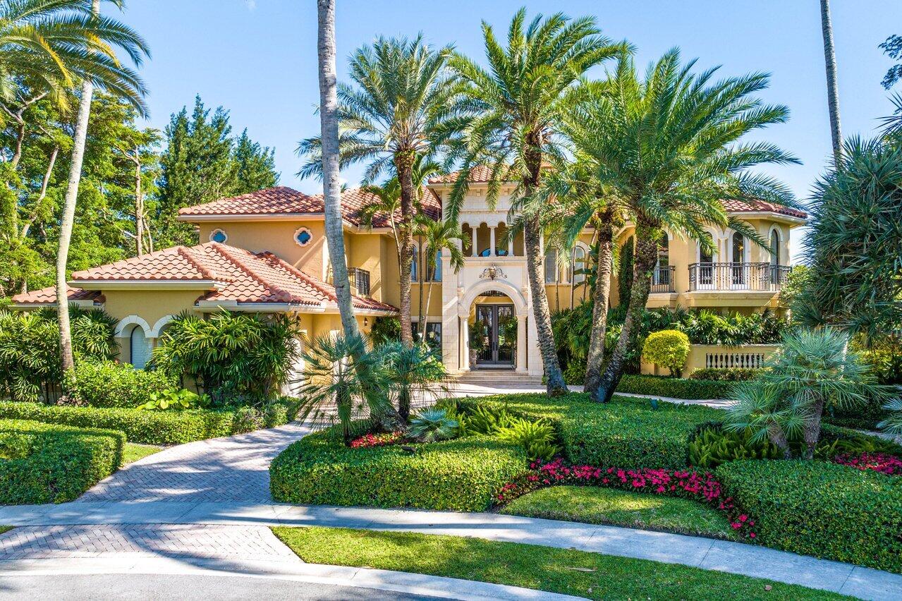 Introducing the pièce de résistance of the Polo Club, this two-story estate is a symphony of elegance and refinement. Boasting 8 bedrooms with an additional office and 9.5 baths, it stands as a testament to refined living. As you approach the home down the quaint cul-de-sac into the circular driveway, the distinguished 3 car plus golf cart garage commands attention. Walking through the grand doors, the foyer is accentuated by a magnificent wrought iron and stone staircase serving as a captivating centerpiece. Transitioning into the great room, you cannot help but take note of the impressive scale and magnitude of the interior. The expansive space is adorned with soaring ceilings, cascading natural light, a striking fireplace, and regal embellishments. Floor-to-ceiling windows offer > panoramic views of the private pool and patio with the gleaming lake behind. Adjacent, a sophisticated sit-down wet bar invites guests to indulge in luxurious entertainment. Offering a smooth transition into the grand dining room, a picturesque setting with verdant surroundings enhancing the ambiance. The gourmet kitchen, complemented by an attached large walk-in pantry, offers ample storage and endless culinary possibilities. Adjoining the kitchen, an eat-in dining space, and a living room provide great flow and ease of living. Outdoors, the backyard oasis beckons as the sweeping lake views cascade in the background. The covered verandah offers a lounging area, bar, and summer kitchen including a barbeque and a dining space. The entirety of the private pool features a custom mosaic tile surround, with a fountain and spillover spa to epitomize outdoor South Florida living. Back inside, the primary bedroom suite is a sanctuary unto itself, with a spacious retreat and double French doors accessing the covered patio. The lavish suite continues to feature dual walk-in closets, dual water closets, a sumptuous spa-like tub, and a statement walk-in shower. Just outside the primary suite is a private office for added convenience. Downstairs, two generously sized bedrooms include ensuite bathrooms and large closet space. Ascending the staircase, guests are greeted by a loft, offering respite and relaxation. Each of the five ensuite bedrooms on the upper level exudes its own unique charm, with one of them including a private balcony overlooking the scenic lakeside vista. In every aspect, this showpiece home is the epitome of elegance and style. It's located in the prestigious Vintage Oaks section of The Polo Club. Access to the world-class amenities of country club living is at your fingertips.