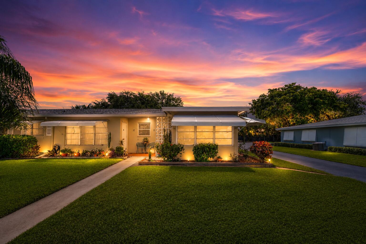 Move-in ready 2BR/2BA villa in the sought-after 55+ community of High Point of Delray Beach. This bright and beautifully maintained 1,175 sq ft home blends mid-century character with tasteful, modern updates. The remodeled kitchen shines with white shaker cabinetry, granite countertops, a subway tile backsplash, crown molding, and stainless steel appliances. An open living and dining area features rich wood-look flooring, a breakfast bar, and a charming built-in banquette nook — all filled with natural light. Both bedrooms are generously sized, including a primary retreat with custom built-in wardrobe and storage. The updated baths offer granite-topped vanities and a sleek walk-in shower, and you'll love the convenience of a full-size in-unit washer and dryer. Out front, a glass-enclosed Florida room and classic retractable awnings add bonus living space and timeless curb appeal. High Point offers resort-style amenities including a clubhouse, heated pool, and an active social calendar, all just minutes from downtown Delray's vibrant dining, shopping, and beaches. A rare opportunity to own a turnkey home in one of Delray's most established communities!