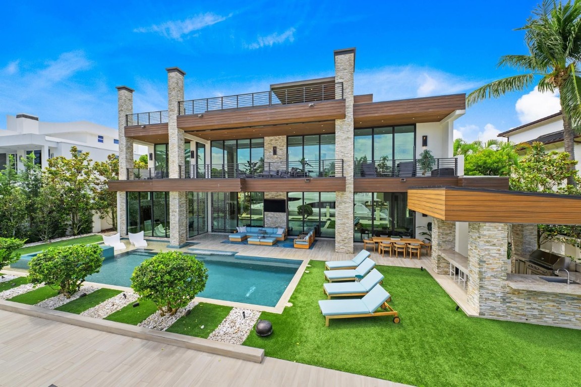 Guard-gated Seven Isles sanctuary. FULLY FURNISHED custom deepwater estate with 103ft concrete dock delivers modern sophistication and the ultimate entertainer's floorplan. Three-level design features elevator, dual primary suites (1st & 2nd floors), chef's kitchen with Subzero, Wolf, Hansgrohe & Toto, 350+ bottle wine cellar. Premium Lutron automation & security throughout. Expansive bedroom suites plus theater, office, gym, loft, sky lounge, rooftop putting green, three fireplaces. Museum-quality custom finishes elevate every detail. Three-bay garage, resort-style pool & summer kitchen. Seven Isles' finest offering.