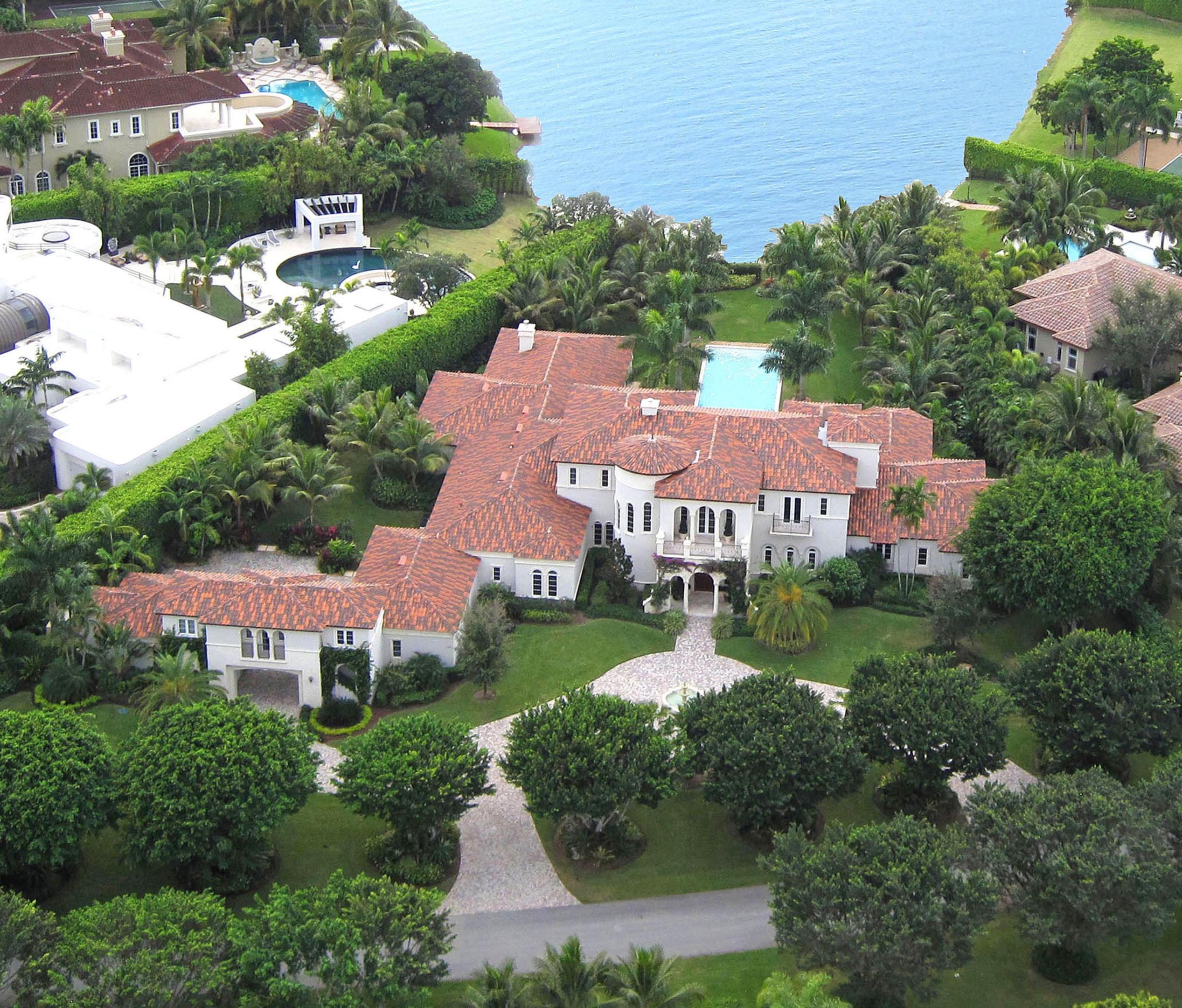 Newly renovated throughout, this Contemporary-inspired lakefront estate captures a long southwesterly water view from 1.43± acres of tropically landscaped grounds.  The stately main residence is accompanied by separate self-contained guest quarters in the carriage house, which has a drive-through bay to a discreet parking court by the five-bay garage.  A columned loggia centers on the lake view across the 65±foot-long vanishing-edge pool and spa lined by statuesque palms on lush lawns that sweep to the shore.  Another loggia serves as an outdoor living/dining room with an elegant fireplace, a summer kitchen, and full cabana bath. One of the finest in Long Lake Estates, this lakefront showplace has just been newly renovated throughout, with no expense spared, as the home of one of the Hamptons' top custom builders. Blending refined Palm Beach elegance and fresh, trend-setting Hamptons style, this lakefront showplace has just undergone a two-year, $4 Million top-to-bottom renovation.. No detail has been overlooked and no expense spared in the stunning renewal of this seven-bedroom residence designed by award-winning architect Randall Stofft in a sprawling tropical paradise where long water views stretch to the southwest and capture romantic sunsets.

Approached by a meandering drive that encircles a tiered fountain, the Contemporary-inspired villa is a picturesque vision on lush estate grounds hidden away among mature trees and privacy hedges. With drama and grace, the soaring entrance hall introduces the chic, understated interiors finished in a soft tone-on-tone palette. High-end amenities and the latest advances in technology make every aspect of the residence function beautifully for private living or entertaining on any scale. 

The living room opens to a loggia viewing the lake over the vanishing-edge pool, while the family room leads to another lakeside loggia fashioned as a true outdoor living room appointed with a fireplace and an open-air kitchen. All of the bedrooms have en-suite baths and feature a luxe first-floor master retreat in addition to a separate guest house above the five-bay garage. Offering the ultimate in resort-style living, this impressive as-new estate is one of the finest residences in Boca Raton's ultra-private Long Lake Estates. 

Location 
Twin Lake Drive, Boca Raton, Florida. Featuring a guard-gated entry and its own patrol service, Long Lake Estates is a prestigious enclave of 126 large estates nestled on winding tree-lined streets among scenic lakes and lush park areas. The central Boca Raton location is within easy driving distance of Atlantic Ocean beaches, Mizner Park's world-class shopping and dining, and Boca Raton's private executive airport. 

Property 
Newly renovated throughout, this Contemporary-inspired lakefront estate captures a long southwesterly water view from 1.43Â± acres of tropically landscaped grounds. The stately main residence is accompanied by separate self-contained guest quarters in the carriage house, which has a drive-through bay to a discreet parking court by the five-bay garage. A columned loggia centers on the lake view across the 65Â±foot-long vanishing-edge pool and spa lined by statuesque palms on lush lawns that sweep to the shore. Another loggia serves as an outdoor living/dining room with an elegant fireplace, a summer kitchen, and full cabana bath. 

Residence 
This impressive residence provides a grand total of 15,164Â± square feet with seven bedrooms and nine and a-half baths â€“ including the guest house â€“ plus customized closets, upstairs/downstairs laundry rooms, an elevator, and a full-house generator. Select finishes feature marble and wide-plank wood floors, hand-forged custom balustrades, and impact-glass windows and exterior doors. The baths have Waterworks and Toto fixtures, Thassos marble and dolomite finishes, and custom cabinetry of cerused white oak and walnut. Comprehensive smart-house automation incorporates commercial-grade nine-zone HVAC systems with ultraviolet purification and Nest thermostats, Sonos and Savant audio visual systems with Stealth speakers, Lutron LED lighting, and a sophisticated security system. 

First Floor: Inside the gracious entrance loggia, the double-height marble foyer features a dramatic turret-style staircase and has a powder room adjacent. Directly ahead, views of the pool and lake stretch through the elegant open living room, centered on a fireplace, with arch-topped French doors leading to the loggia. Another fireplace flanked by custom built-ins highlights the library which also opens to the lakeside loggia. Across the gallery, the dining room opens to a private garden and is served by a butler's pantry and climate-controlled wine room. Done in crisp white tones, the epicurean's kitchen includes custom cabinetry, stone counters, a BlueStar gas range, Miele convection/steam ovens, two Miele warming drawers, two Miele dishwashers, and a Sub-Zero refrigerator. French doors join the airy open family/breakfast room to the lakeside loggia with summer kitchen. Next to this room are the custom-fitted theater room and office. Across the foyer, another gallery enters the large private wing that encompasses the master suite. Serene tree-framed lake views fill the comfortably elegant master bedroom through the step-down sitting area where French doors open to the lawns. Two customized wardrobe rooms accompany the suite's two spa-like white marble baths, one with a free-standing soaking tub and frameless glass shower. A separate staff suite is also on this level. 

Second Floor: Arranged off the upstairs gallery, four bedroom suites include two which open to a loggia taking in the lake view and sunset. French doors also lead to the loggia from the open sitting room. 

Guest House: The separate guest house provides a living room, kitchenette, bedroom, and bath. 

DISCLAIMER:The written and verbal information provided including but not limited to prices, measurements, square footages, lot sizes, calculations and statistics have been obtained and conveyed from third parties such as the applicable Multiple Listing Service, public records as well as other sources. All information including that produced by the Sellers or Listing Company are subject to errors, omissions or changes without notice and should be independently verified by any prospect for the purchase of a Property.  The Sellers and Listing Company expressly disclaim any warranty or representation regarding all information.  Prospective purchasers' use of this or any written and verbal information is acknowledgement of this disclaimer and that Prospects shall perform their own due diligence.  Prospective purchasers shall not rely on any written or verbal information provided when entering a contract for sale and purchase.  Some affiliations may not be applicable to certain geographic areas. If your property is currently listed, please do not consider this a solicitation. In the event a Buyer defaults, no commission will be paid to either Broker on the Deposits retained by the Seller.  "No Commissions Paid until Title Passes."  Copyright 2017 Listing Company. All Rights Reserved


The written and verbal information provided including but not limited to prices, measurements, square footages, lot sizes, calculations and statistics have been obtained and conveyed from third parties such as the applicable Multiple Listing Service, public records as well as other sources. All information including that produced by the Sellers or Listing Company are subject to errors, omissions or changes without notice and should be independently verified by any prospect for the purchase of a Property.  The Sellers and Listing Company expressly disclaim any warranty or representation regarding all information.  Prospective purchasers' use of this or any written and verbal information is acknowledgement of this disclaimer and that Prospects shall perform their own due diligence.  Prospective purchasers shal