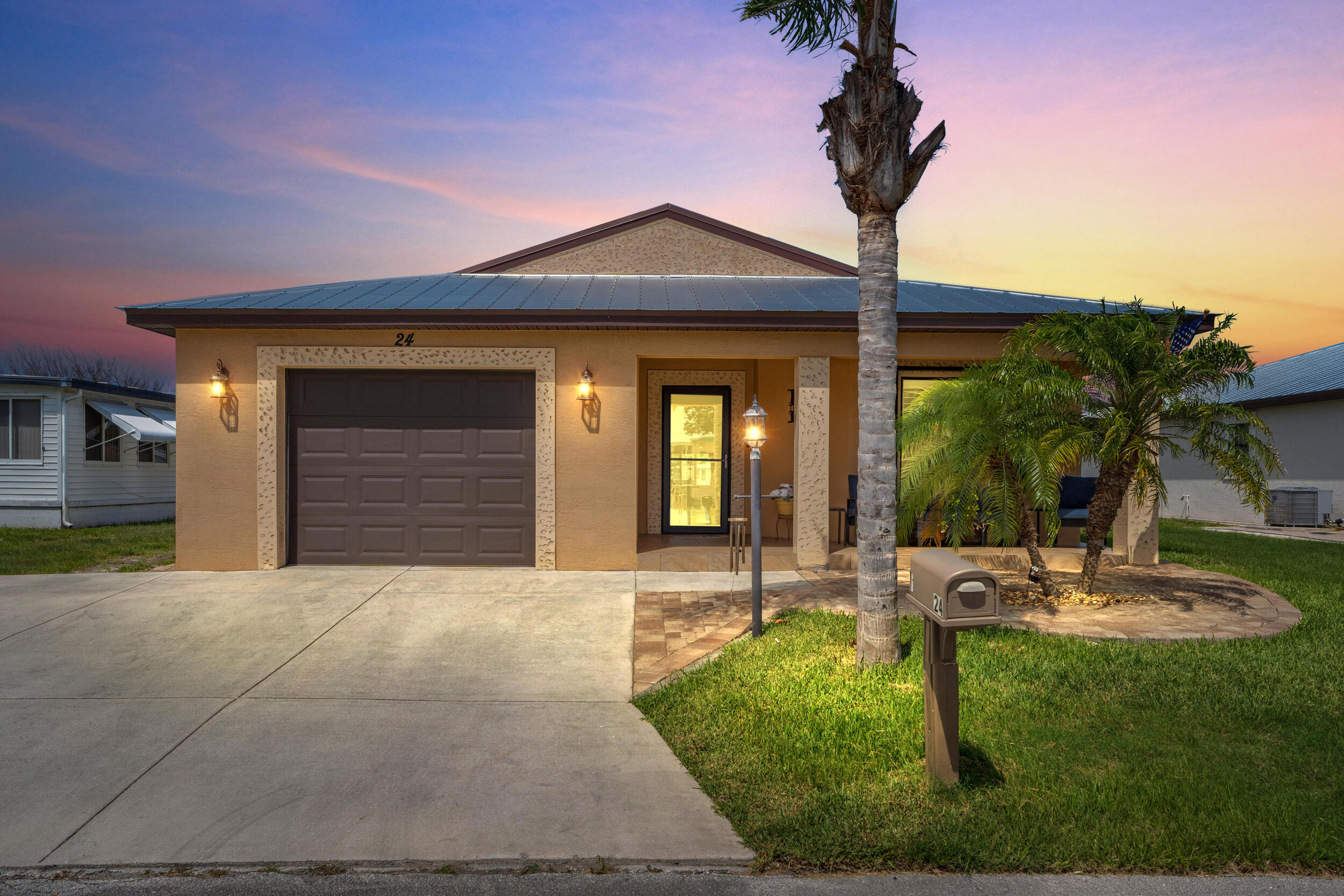 Beautiful waterfront Carlton model at Spanish Lakes 55+ community. This 2018 CBS home sits on an oversized lot and features cherry wood cabinets in the kitchen and bath, granite counters and backsplash and stainless appliances in the kitchen. No carpet! Flooring is tile and wood laminate throughout.  Expansive In this open floor plan, the expansive living room has vaulted ceilings, a dining room nook and it overlooks the air conditioned sun room and pond!  This home has accordian shutters and Metal Roof and extended driveway too. Spanish Lakes residents enjoy a very active community environment plus great amenities including unlimted golf, 2 great pools, pickle ball, tennis and much more!