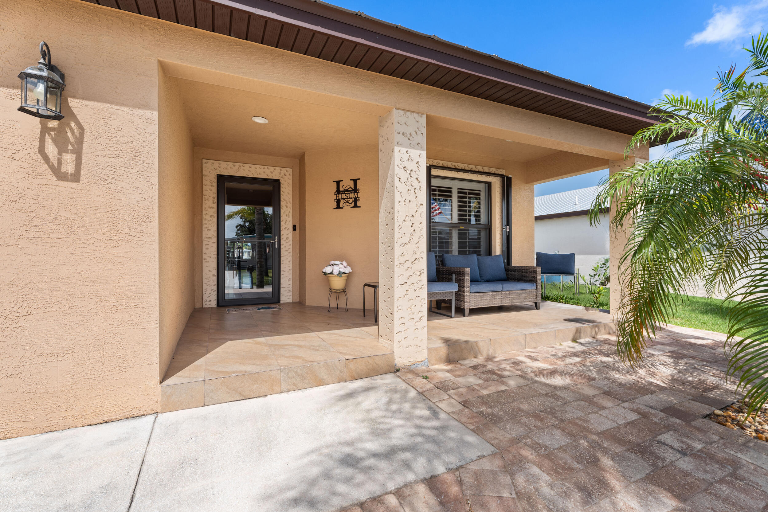 Beautiful waterfront Carlton model at Spanish Lakes 55+ community. This 2018 CBS home sits on an oversized lot and features cherry wood cabinets in the kitchen and bath, granite counters and backsplash and stainless appliances in the kitchen. No carpet! Flooring is tile and wood laminate throughout.  Expansive In this open floor plan, the expansive living room has vaulted ceilings, a dining room nook and it overlooks the air conditioned sun room and pond!  This home has accordian shutters and Metal Roof and extended driveway too. Spanish Lakes residents enjoy a very active community environment plus great amenities including unlimted golf, 2 great pools, pickle ball, tennis and much more!