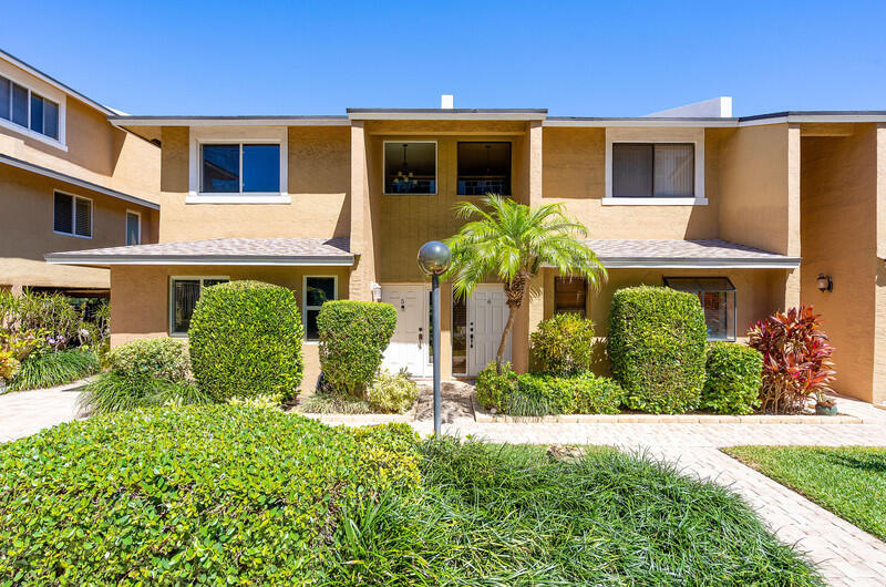 Welcome to Paradise! Experience the luxury of being mere steps from the ocean in this beautiful 2-bedroom, 2.5-bathroom townhouse. Boasting a spacious and airy layout, this home features cathedral ceilings and an abundance of natural light throughout the expansive living space and open-concept kitchen. Both bedrooms are conveniently located on the second floor, offering the privacy and convenience of their own dedicated, stacked master suites. Step outside to your private, oversized open patio—the absolute perfect spot for entertaining guests, dining al fresco, or enjoying the coastal breeze.Located in a fantastic community, a pristine pool sits right outside your front door, and a detached carport provides hassle-free parking.  With a wealth of local restaurants, shopping, and vibrant nightlife all within walking distance, this townhome truly offers the ultimate South Florida lifestyle.