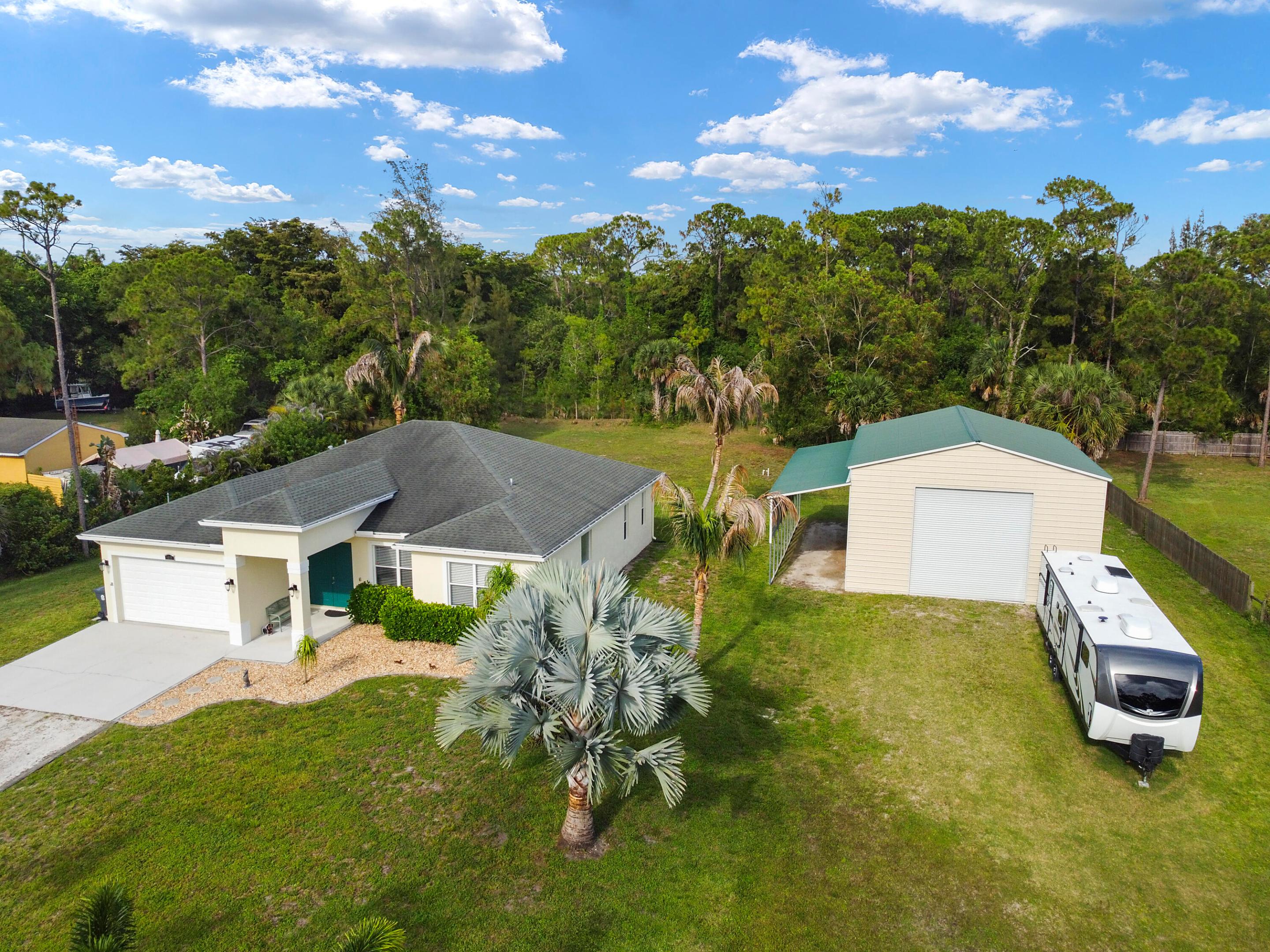 Welcome to your private slice of paradise! Situated on over an acre of land with NO HOA, this beautifully maintained 4-bedroom, 2-bath home offers the perfect blend of modern comfort, functionality, and space to grow. Built in 2016, this move-in ready home features all the modern amenities today's buyers are looking for and has been freshly painted inside and out, creating a bright, clean, and inviting feel from the moment you arrive. Step outside and enjoy endless possibilities with a sprawling yard offering ample room for a pool, outdoor entertaining, pets, toys, or simply enjoying the privacy and open space.  A standout feature of this property is the impressive 1,600+ square-foot detached building/workshop, built in 2022 on a concrete pad, complete with a lean-to for additional covered storage and workspace—perfect for hobbyists, contractors, car enthusiasts, business owners, boat/RV storage, or anyone needing extra flexibility. Conveniently located close to dining, shopping, and A-rated schools, this rare property offers the freedom of country-style living with everyday conveniences just minutes away. Available now and ready to welcome its next homeowner—don't miss this unique opportunity to own space, privacy, and versatility all in one!