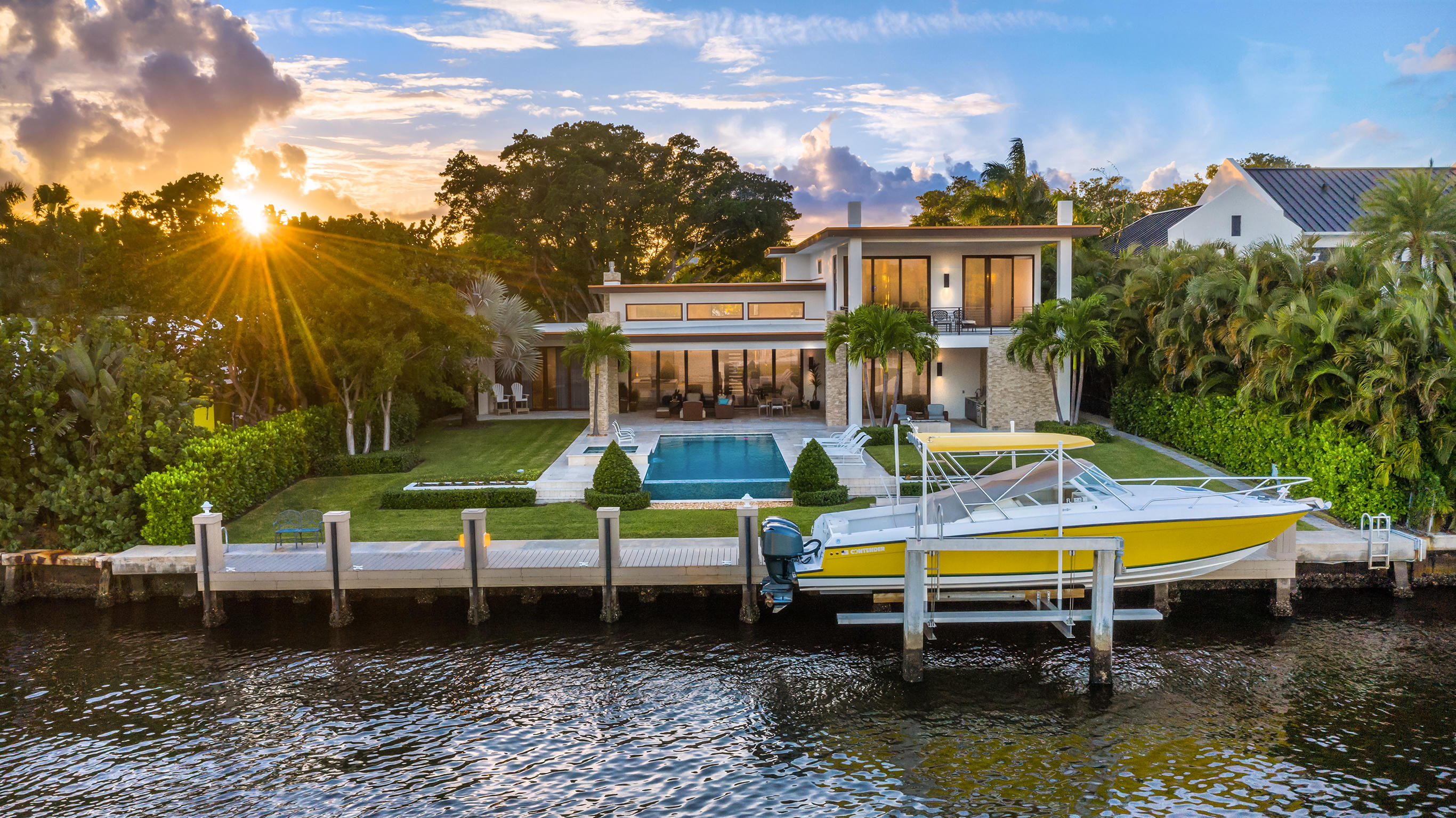 Delray Beach's finest waterfront modern estate is now available. Commanding nearly ½ acre directly on 101 feet of intra-coastal, this masterpiece is a true one of a kind. Sprawling over 9300 total square feet this modern marvel offers the most discerning buyer excellence in every detail. Approach to a secure gated grand entrance that is highlighted by a long stepping stone styled driveway tucked under a magnificent decades old banyan tree. As you step up to the home, bubbling water features and sheets of glass welcome you to unobstructed views through the home. Enter the foyer and great rooms with soaring 16 foot ceilings, walls of imported Italian glass sliding doors, and an elegant fireplace all flooded by additional sunlight from the well placed transom.... ...windows. The wide open kitchen is suitable for a world class chef with a multitude of working spaces, ultra-high end Miele and Jenn Air appliances, 6 burner natural gas stove, quartz countertops, massive functional island and imported European cabinetry. The expansive ground floor master suite has views of the expansive back yard and pool and is finished with warm elegant wood textures, his and her sides to the master bath and a shared walk in shower. Entertaining here is a breeze with nearly 1000 square feet of covered patios and deck areas opening to a totally private pool and back yard framed in by 15' hedges on both sides.  Downstairs there is an additional office, private guest suite, powder room and a full cabana bathroom. A bonus loft / game room and 2 bedroom suites are upstairs that lead to another 350 sq foot covered balcony overlooking the pool and waterway. As one of a kind as this home is, the views across the intracoastal are just as unique. This estate is located directly across from one of the few bird sanctuaries affording absolute privacy rarely found when living on the water. Additional features include an oversized 3 car garage that is 24' deep and has ceiling heights that will allow for additional car lifts, an additional air conditioned storage / flex space room for ultimate convenience, fire pits, full summer kitchen, spa and 20K pound 4 post boat lift with high speed motors. All this is located in the famed Palm Trail neighborhood steps from Atlantic Avenue, downtown Delray Beach and only .7 miles to the beach.