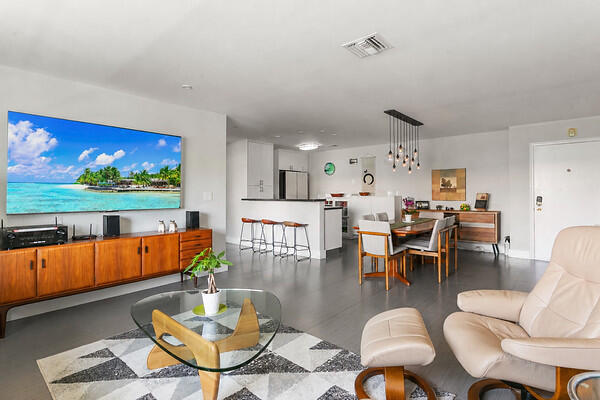 A Manor Grove 2/2 updated condo w/ comtemporary & sleek finishes throughout. Most unusual kitchen open on two sides w/ breakfast bar makes for a bright & spacious floorplan. New refrigerator, microwave & impact glass windows. Also new roof, new mailboxes, new exterior painting w/ new color scheme & parking lot just paved. Bld tented this yr. Full size stacked washer/dryer in unit & tankless hot water heater. Tile floors throughout w/ no carpet anywhere. Walk-in showers in both bathrooms w/ glass enclosures. Second bedroom converted to office or den. Southern exposure for a sunny & cheerful living space w/ drapes or blinds for all windows. Pool w/ spacious deck & BBQ area. The poolside clubhouse w/ kitchen facility & cabana baths. Available Circuit Shuttle Service p/u right at your door. A must see one of a kind Manor Grove update...