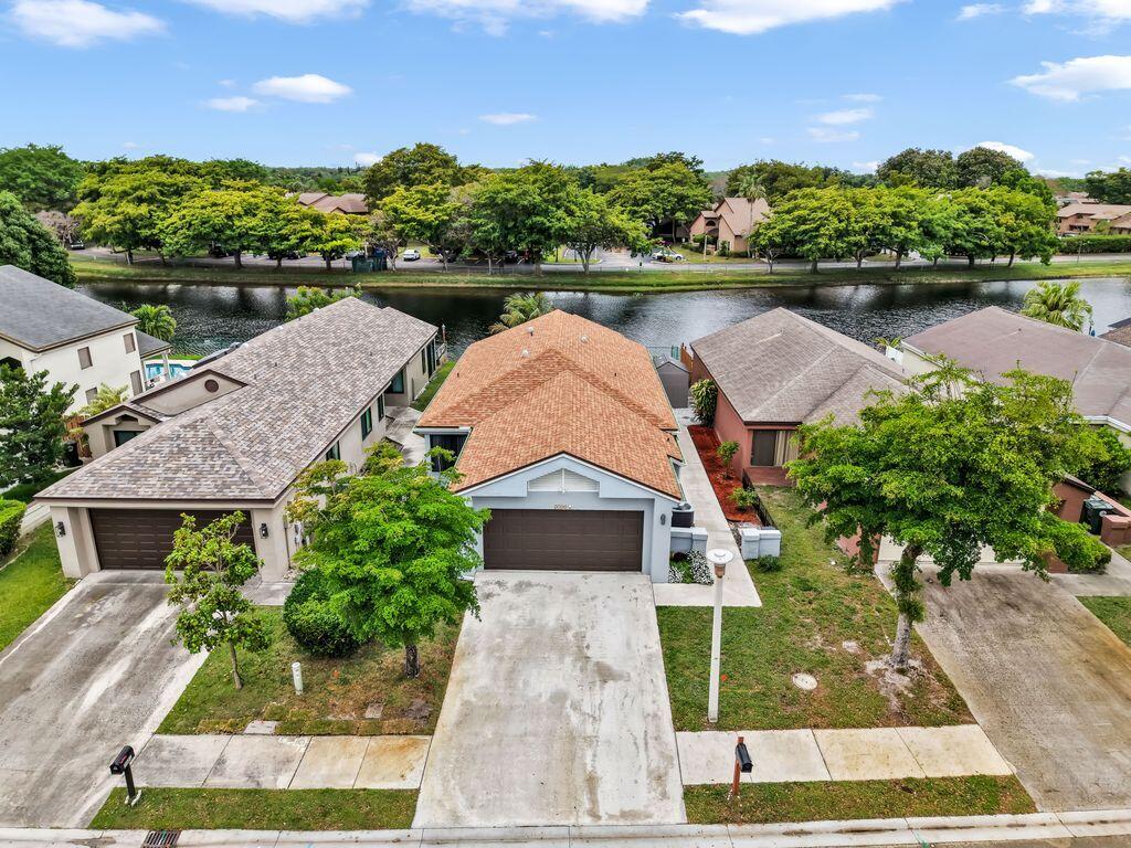 Stunning lakefront 2 bedroom with spacious den that can be converted to a 3rd bedroom or home office,  with 2-car garage located in a desirable guard-gated community!  Home features beautifully upgraded bathrooms and a functional, open layout perfect for comfortable living and entertaining. Enjoy serene water views right from your backyard. Community amenities include basketball courts, tennis courts, resort-style swimming pool, and playground. Conveniently located near shopping, dining, and major roadways, this home offers the perfect blend of lifestyle, location, and value!